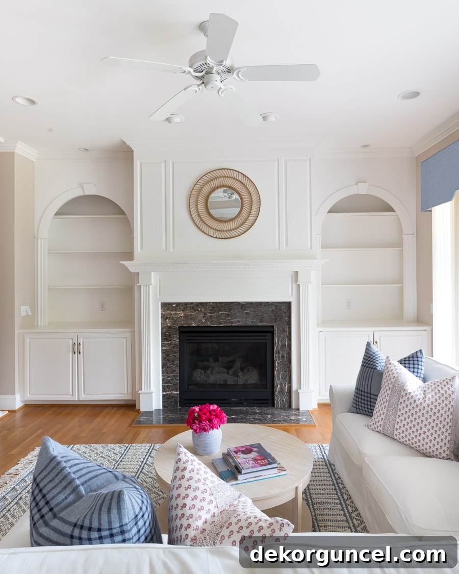 Modernized family room with spray painted brass fan and recessed lighting trim, showcasing a cohesive updated look.