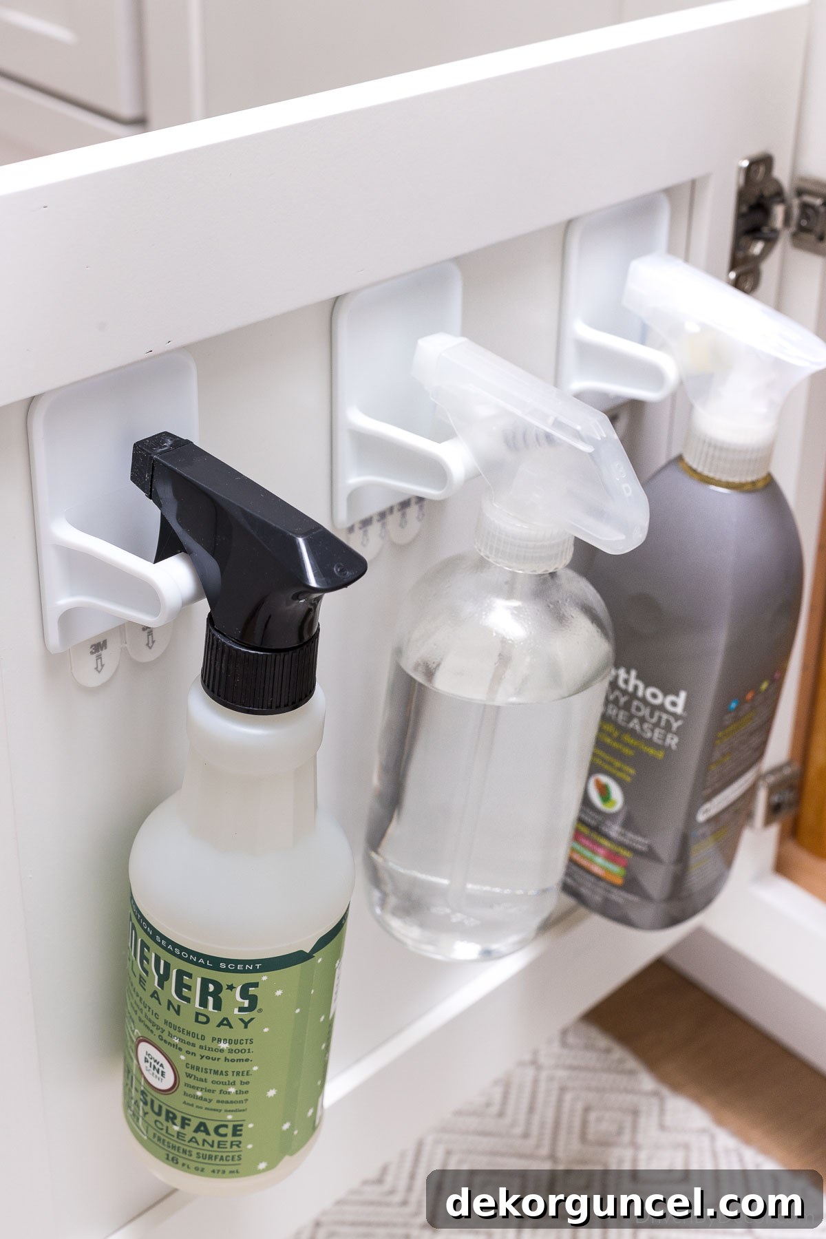20 Genius Home Organization Hacks for a Clutter-Free Home 2 Spray bottle hangers on back of kitchen cabinet doors for hidden organization