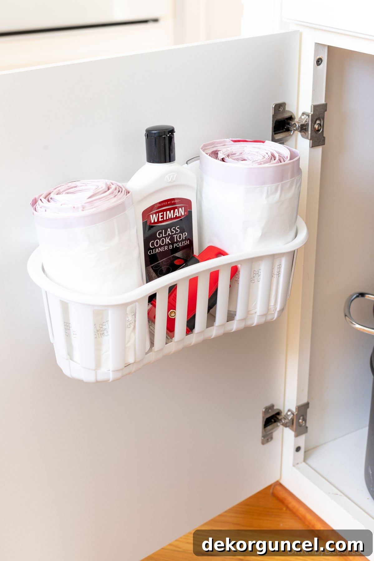 20 Genius Home Organization Hacks for a Clutter-Free Home 11 Cabinet caddy holding trash bags on cabinet door for easy access