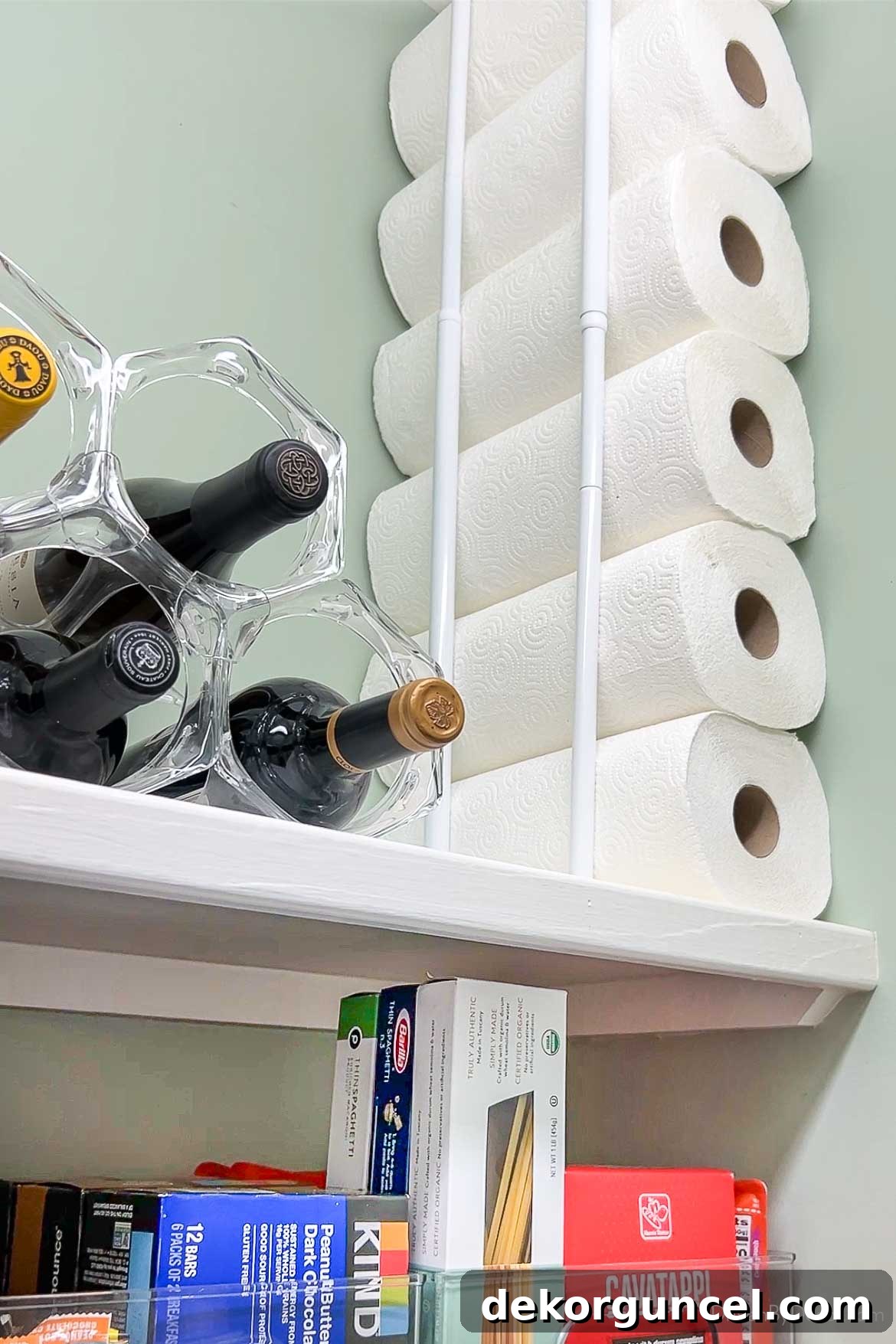 20 Genius Home Organization Hacks for a Clutter-Free Home 4 Paper towels stored vertically in pantry using tension rods