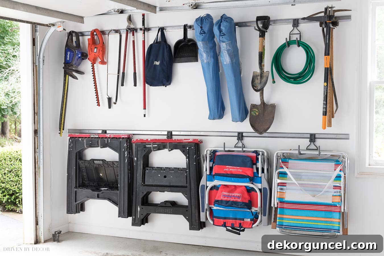 20 Genius Home Organization Hacks for a Clutter-Free Home 34 Tools and chairs neatly hung on a track system in an organized garage