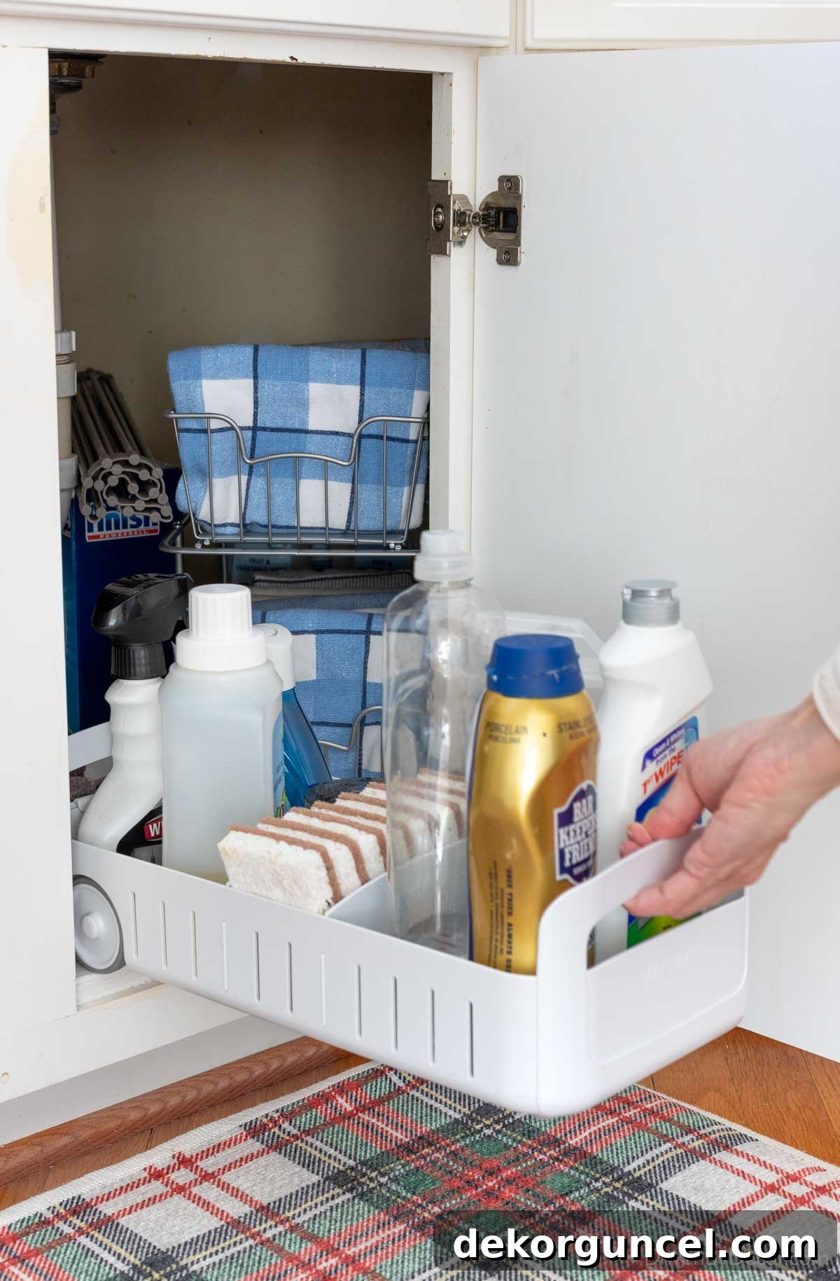 20 Genius Home Organization Hacks for a Clutter-Free Home 8 Rolling organizer pulled out from under kitchen sink, showcasing organized cleaning supplies