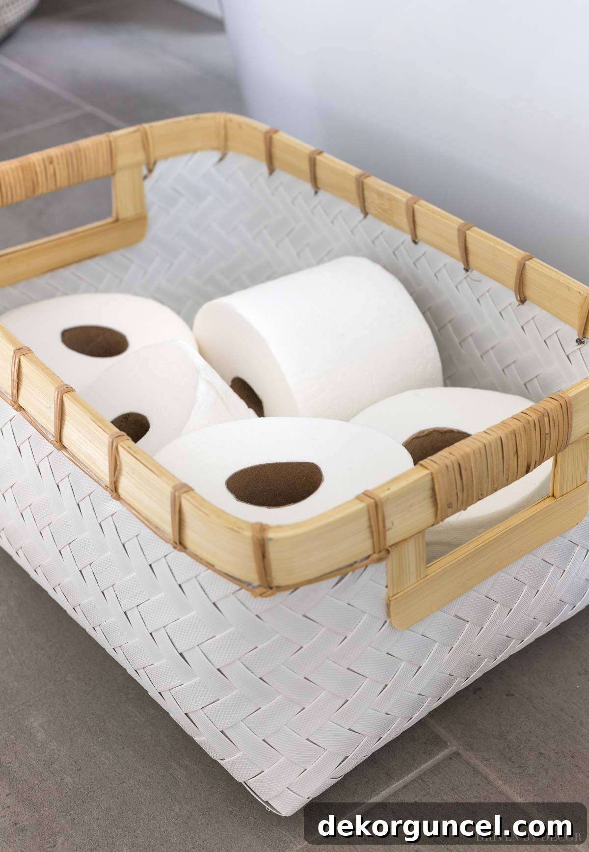 Effortless Bathroom Style for an Instant Update 12 White woven basket storing toilet paper rolls on floating shelves in a master bathroom