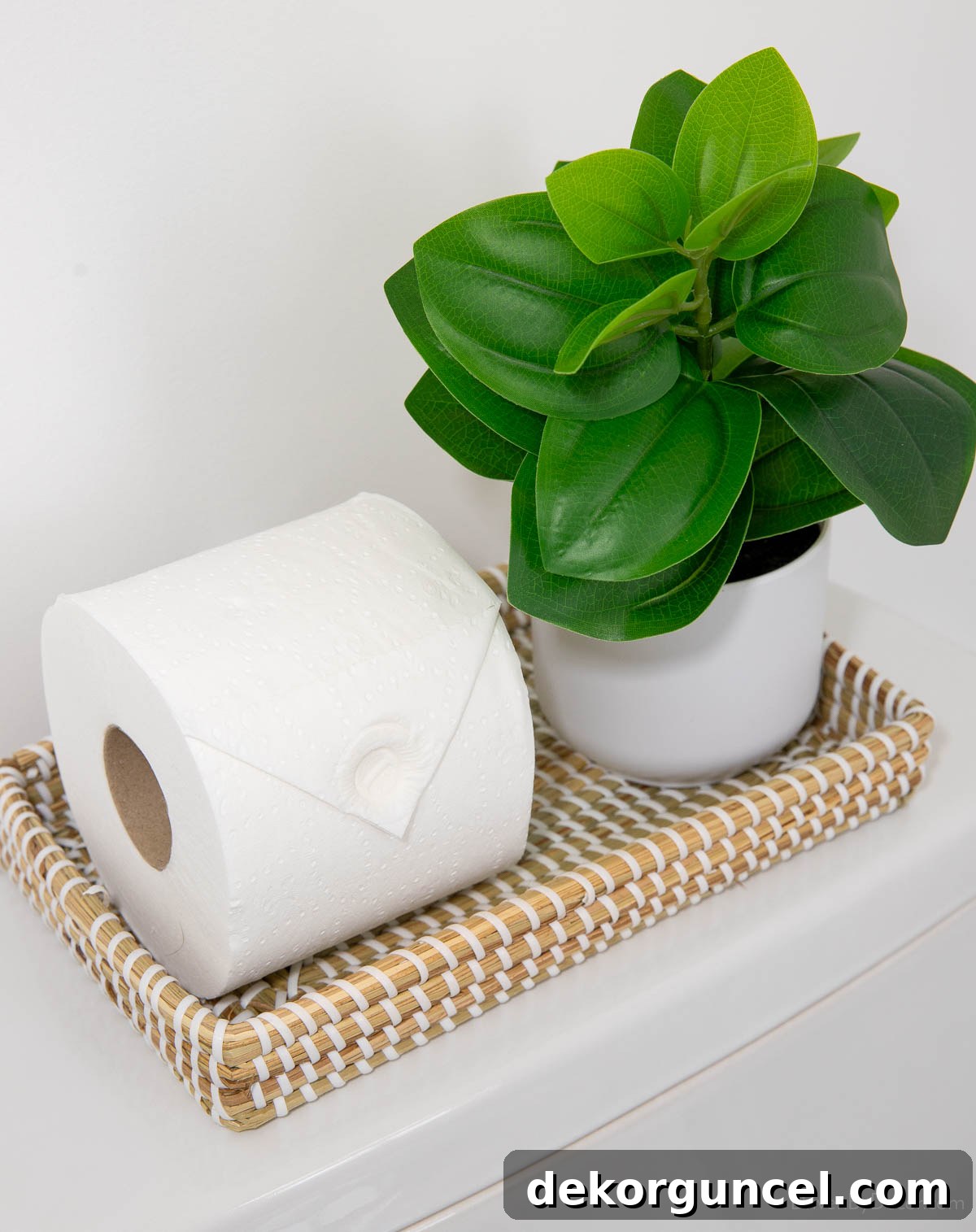 Effortless Bathroom Style for an Instant Update 13 Woven toilet tray with a small plant, offering an elegant toilet tank decor idea