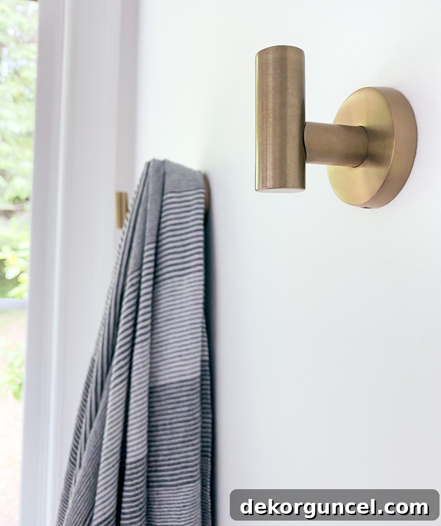 Effortless Bathroom Style for an Instant Update 15 Gorgeous golden champagne robe and towel hooks, a beautiful bathroom decor idea