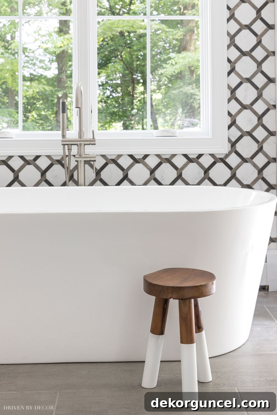Effortless Bathroom Style for an Instant Update 17 Charming wood stool placed next to a bathtub, showcasing excellent bathroom decor ideas