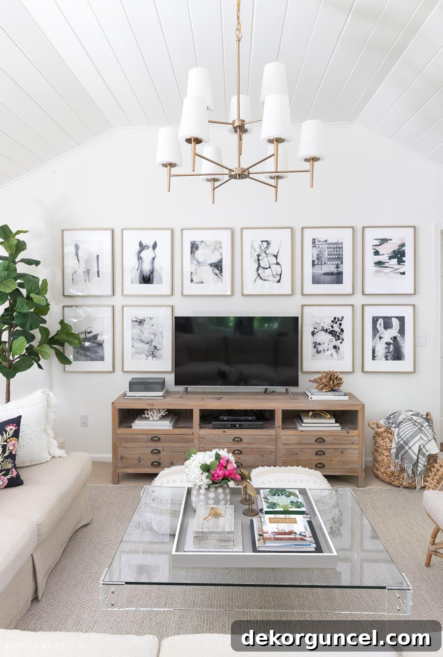 A stunning grid gallery wall surrounding a TV console, an easy and impactful living room wall decor idea.