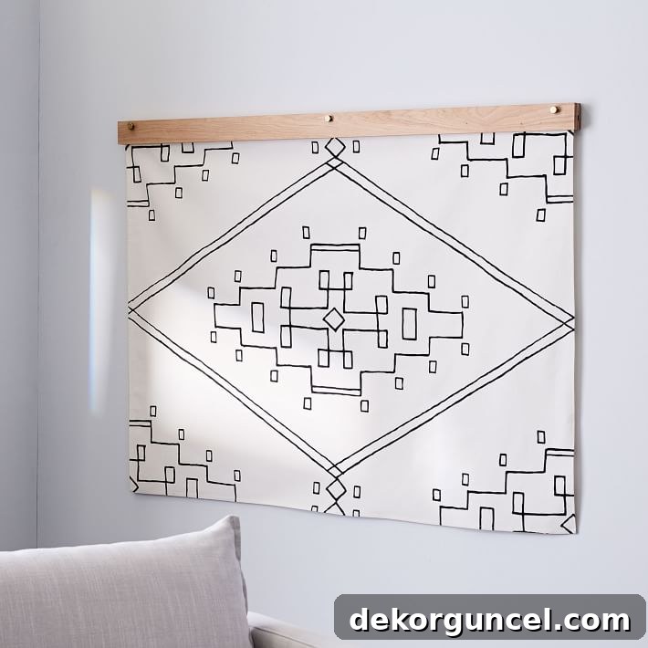 A stylish black and white tapestry hung with a quilt hanger, adding texture and warmth to living room wall decor.