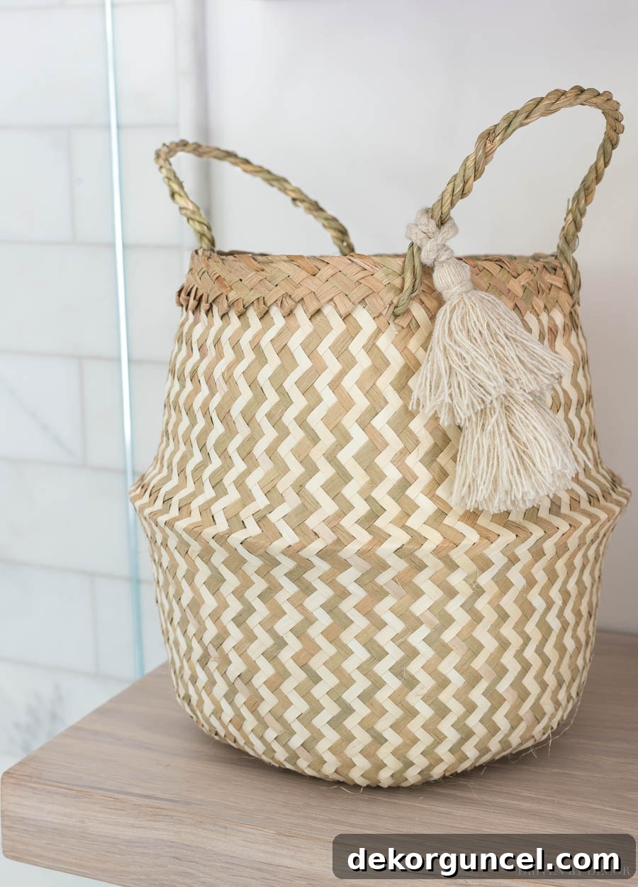 A cute tasseled belly basket used for storing washcloths in the master bathroom
