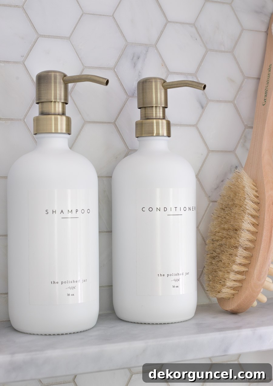 Elegant pump bottles for shampoo and conditioner, perfectly complementing the marble shower niche