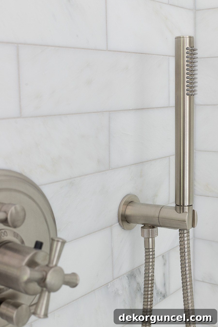Innovative hand shower design resting on a simple hook, avoiding a bulky shower bar