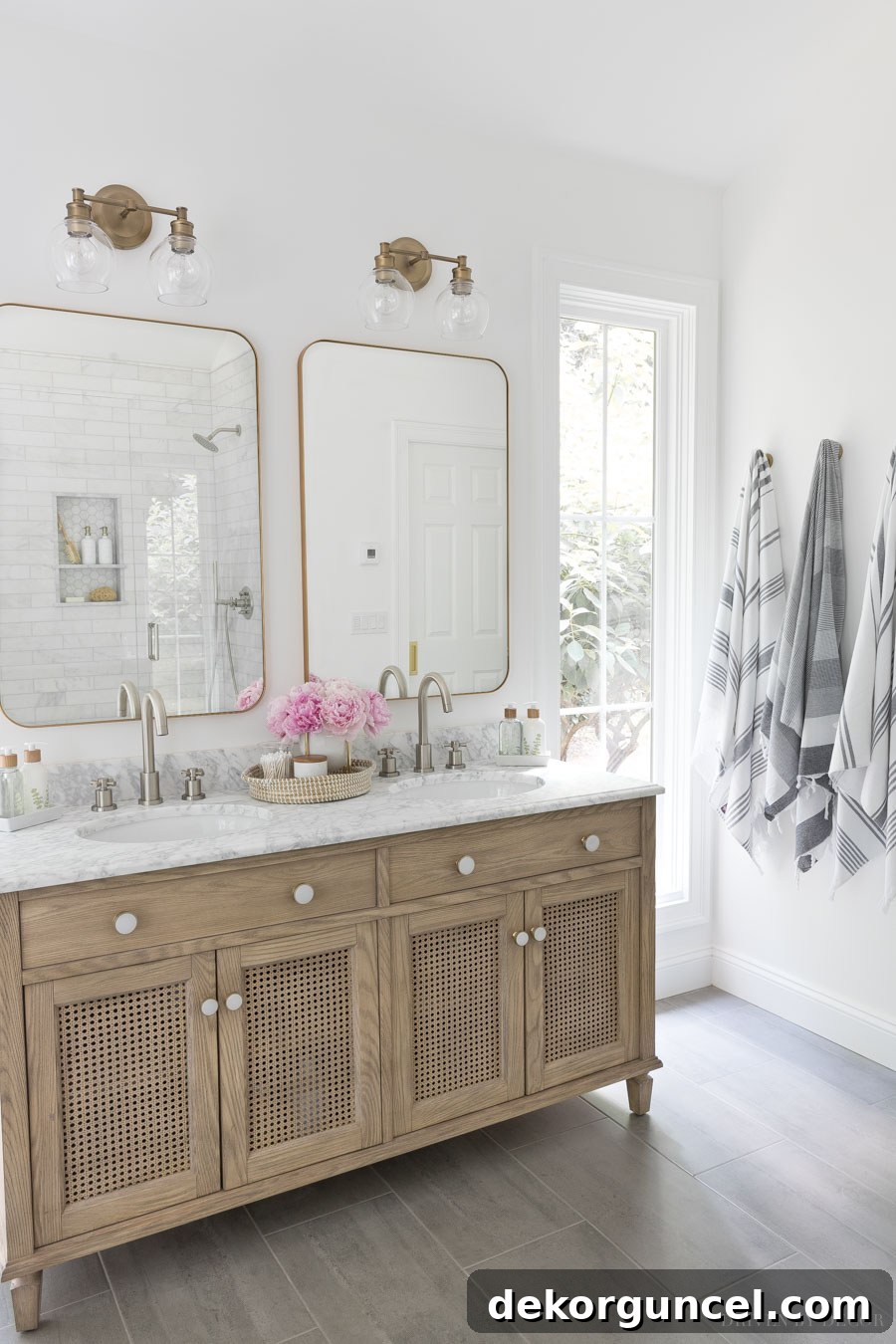 The well-designed layout of the double vanity flanked by narrow windows, with elegant robe hooks for towels on the adjacent wall