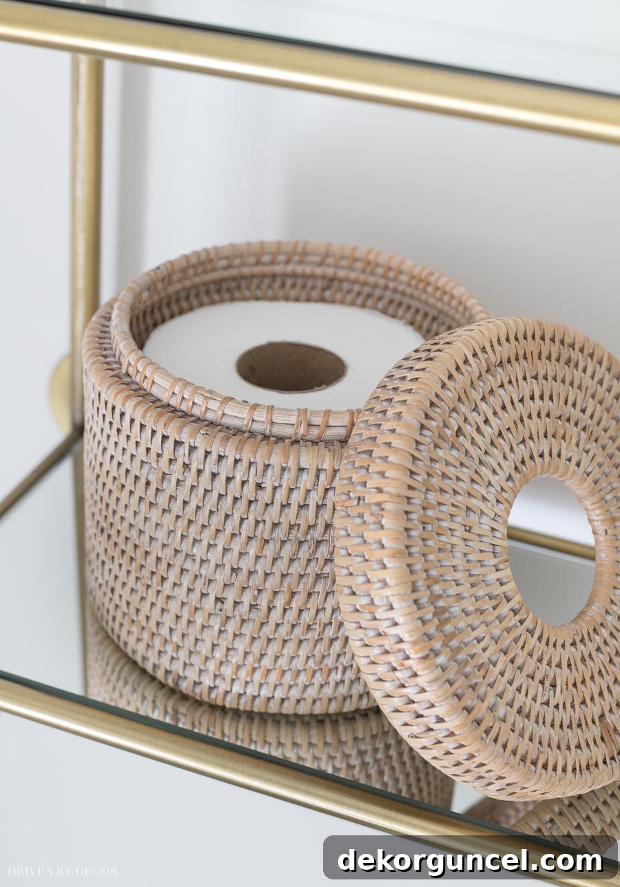 A unique round rattan holder for an extra roll of toilet paper, adding charm to the water closet