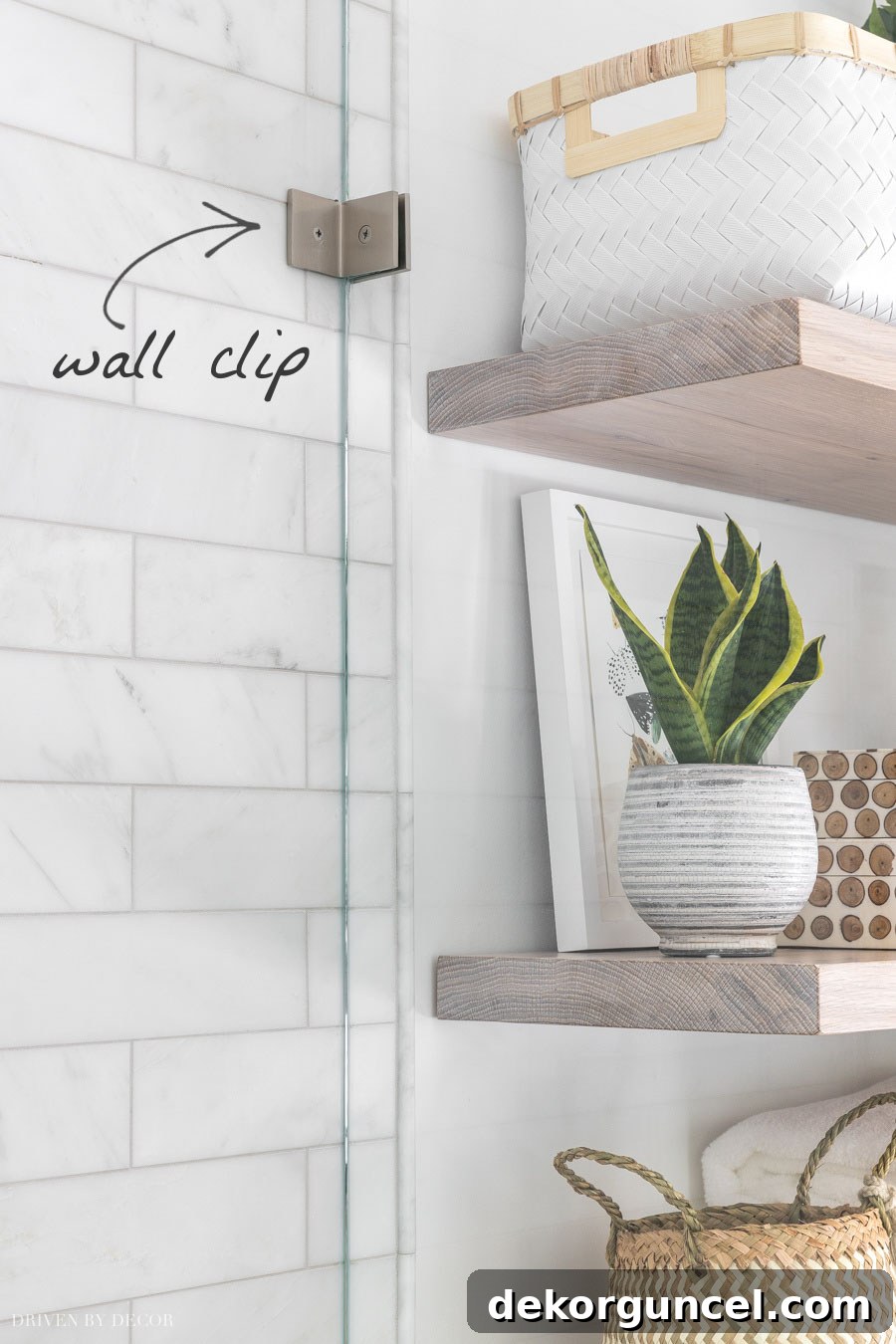 Glass Shower Enclosures What To Pay And What To Skip 3 Close-up of a standard wall clip used in frameless glass shower enclosures for a minimalist aesthetic.