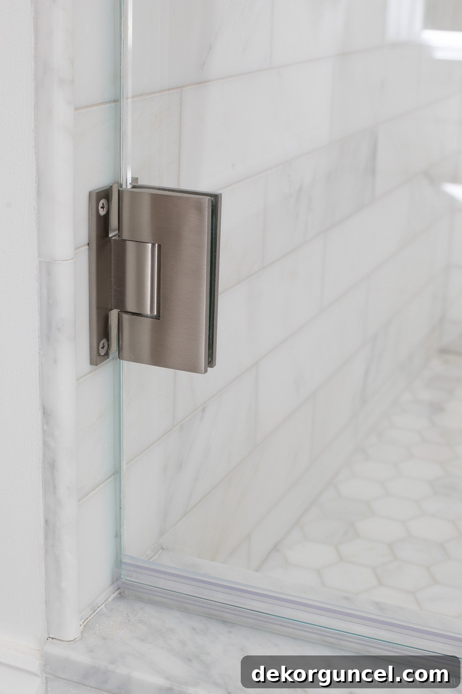 Glass Shower Enclosures What To Pay And What To Skip 8 Close-up view of a standard wall hinge for a glass shower enclosure door, illustrating robust support.