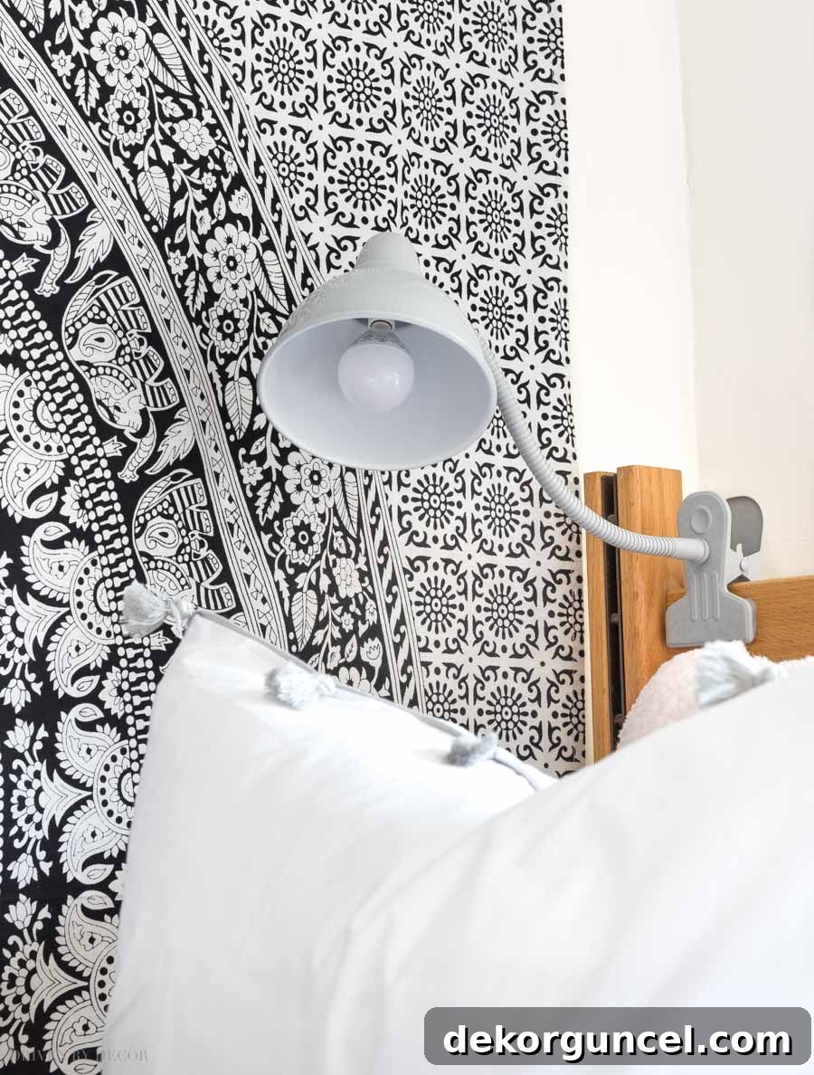 Dorm Room Essentials The Complete Guide 3 A versatile clip-on task light illuminating a dorm bed, perfect for reading or studying without taking up desk space.