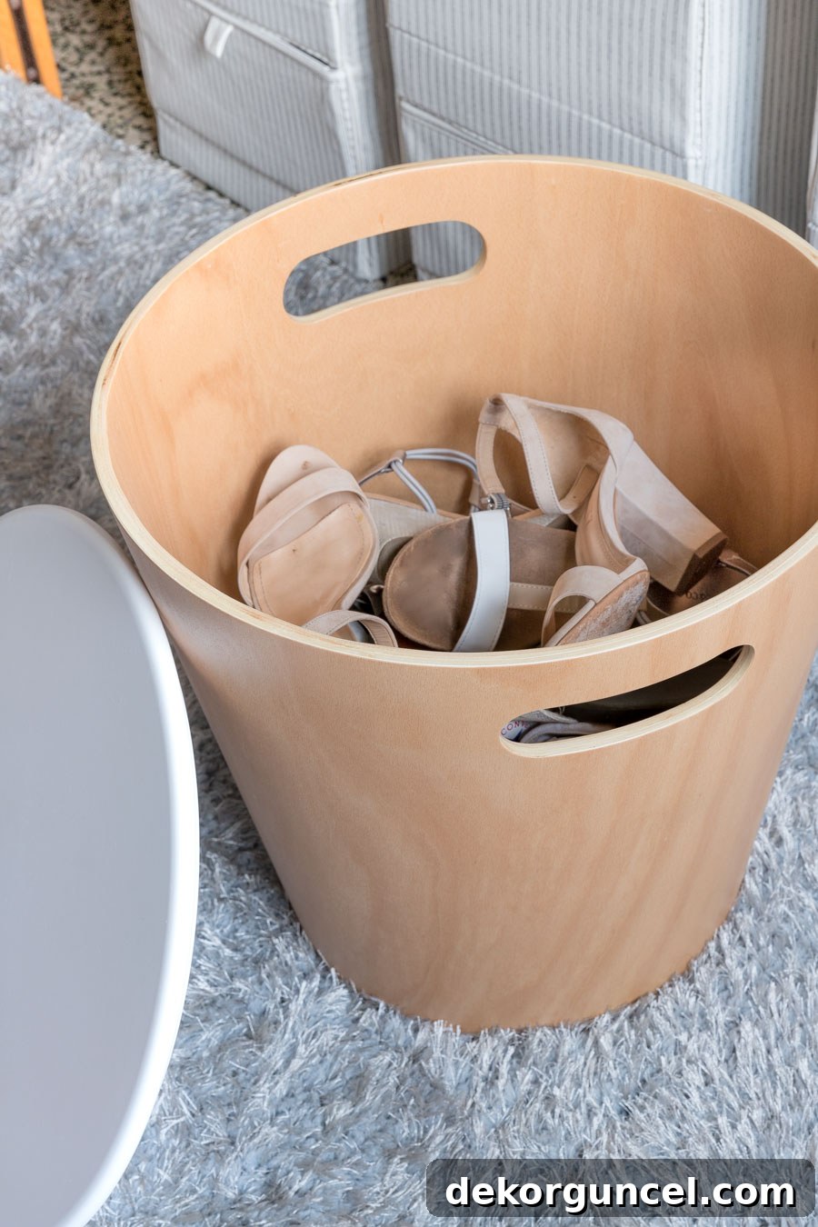 Dorm Room Essentials The Complete Guide 5 A charming wood storage stool, cleverly designed to store shoes, standing beside a dorm bed.