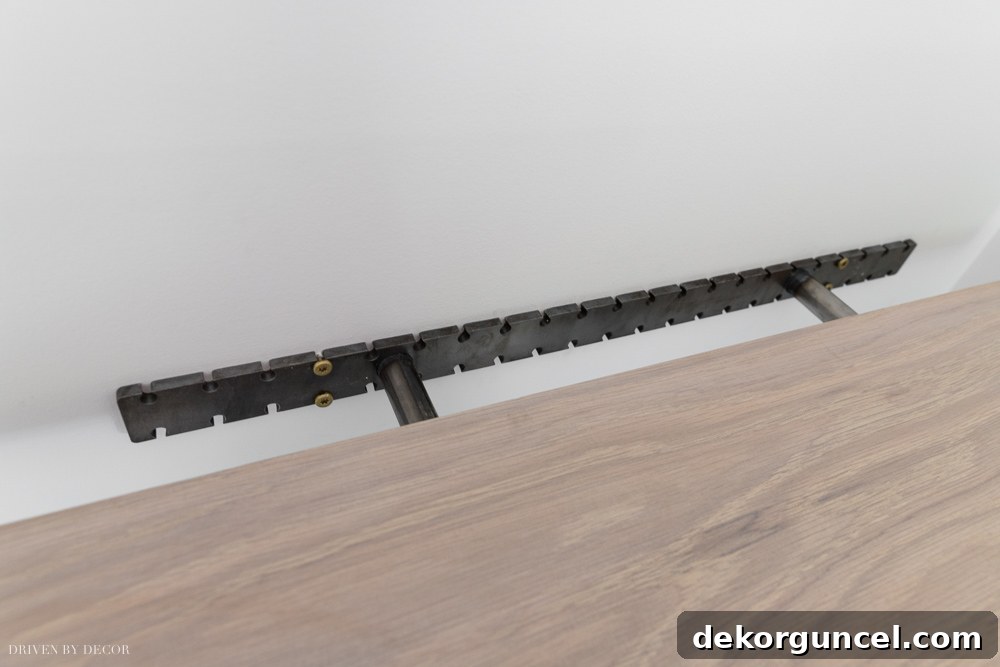 The final step of installation: carefully sliding our floating wood shelves onto their secured brackets for a seamless look.
