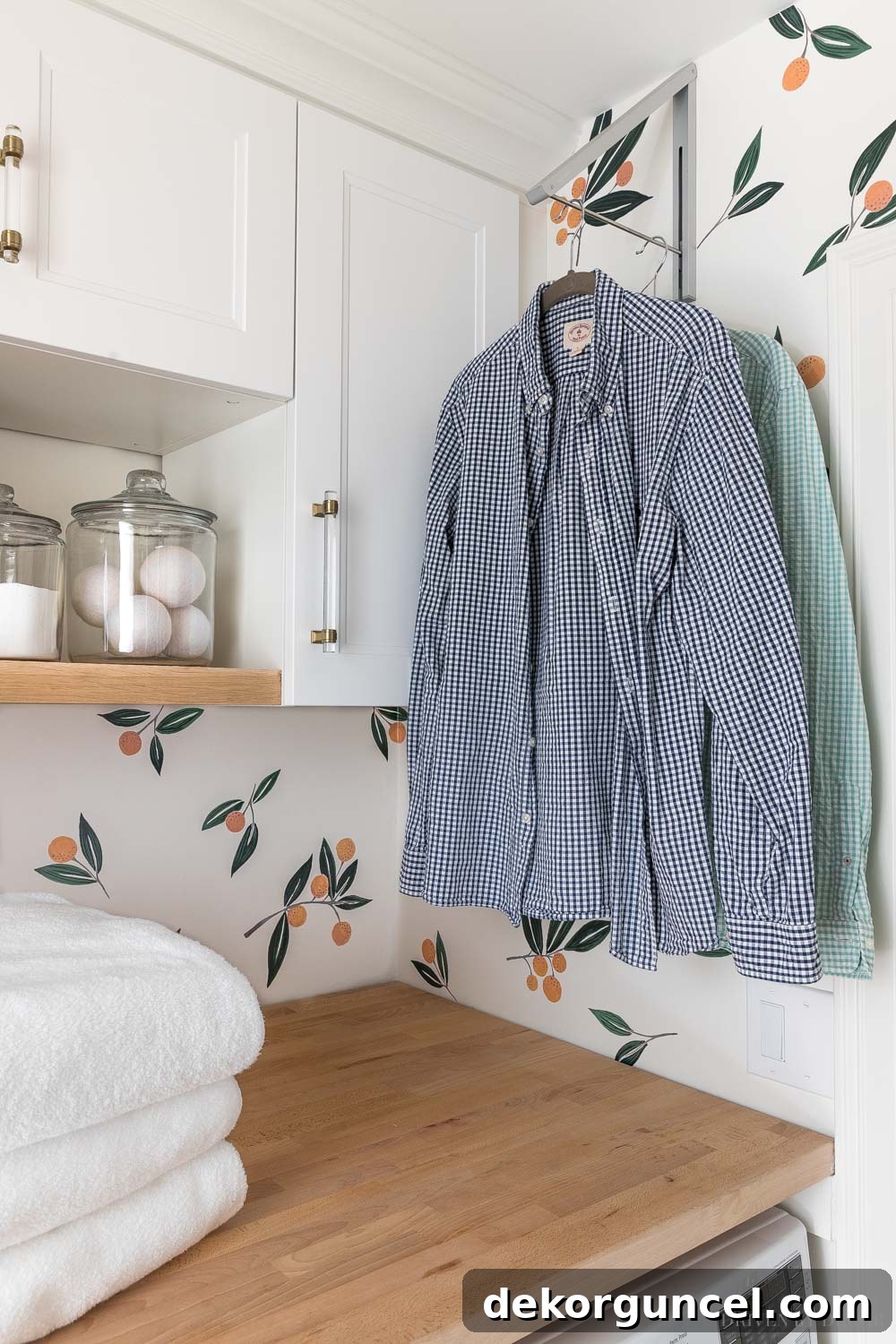 Retractable clothes rack mounted on a laundry room wall, offering a convenient space for air-drying clothes.