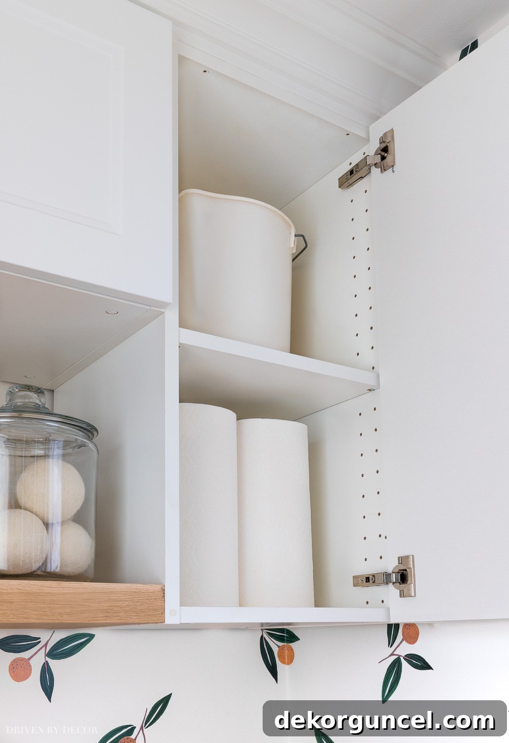 Interior view of IKEA Axstad and Sektion laundry room cabinets, showcasing organized Utrusta shelves and ample storage space.