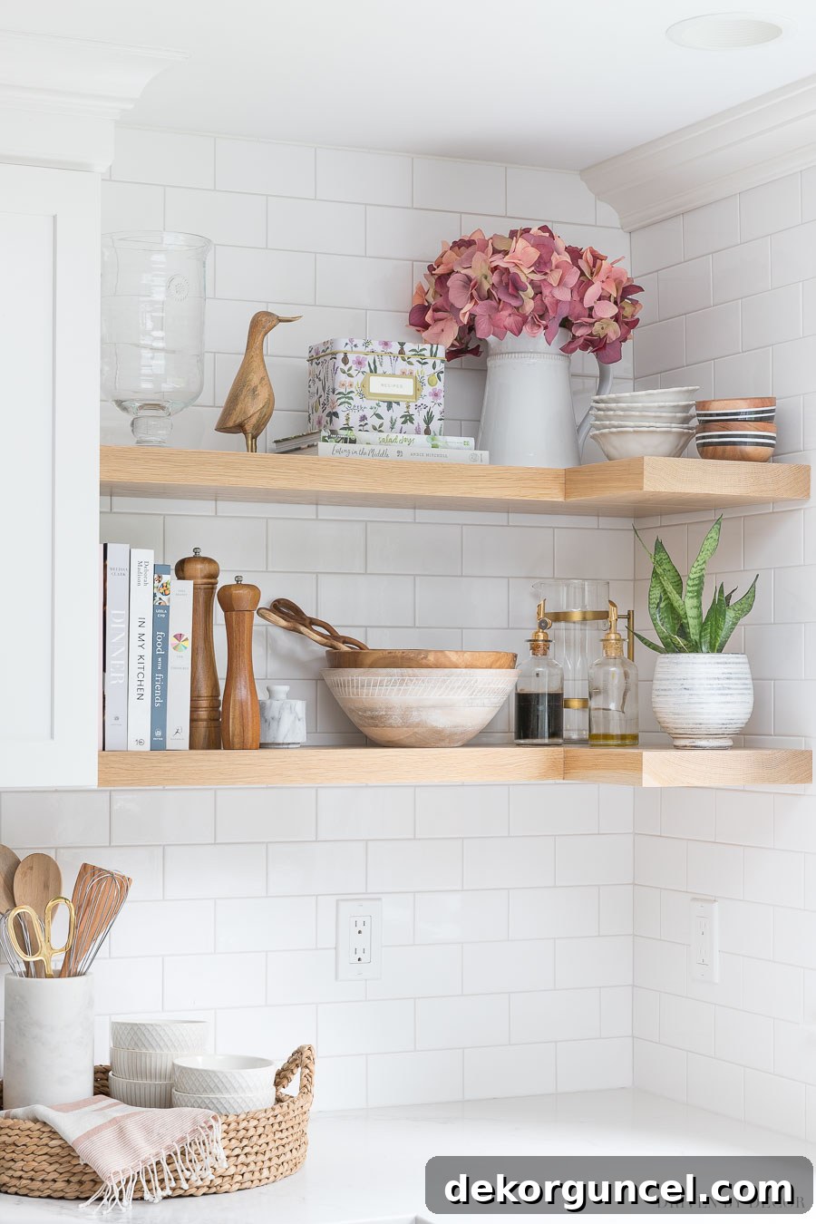 Close-up of faux hydrangeas in a pitcher on an open kitchen shelf, demonstrating the warm tone of white oak that would be used in the laundry room.