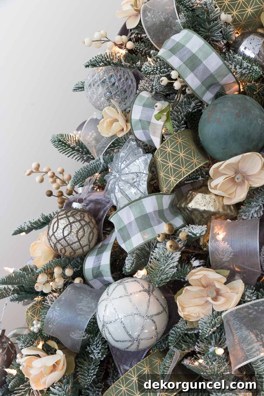 How to Perfectly Flock a Christmas Tree 12 A gorgeously flocked Christmas tree, beautifully adorned with ribbons and ornaments, showcasing a stunning winter wonderland aesthetic that perfectly complements the room's decor.