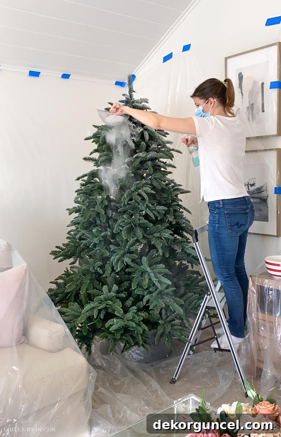 How to Perfectly Flock a Christmas Tree 6 A visual guide demonstrating the essential sprinkle and spray technique for flocking a Christmas tree, showing how to simultaneously sift flocking powder and mist it with water for optimal adhesion and a natural, snowy finish.