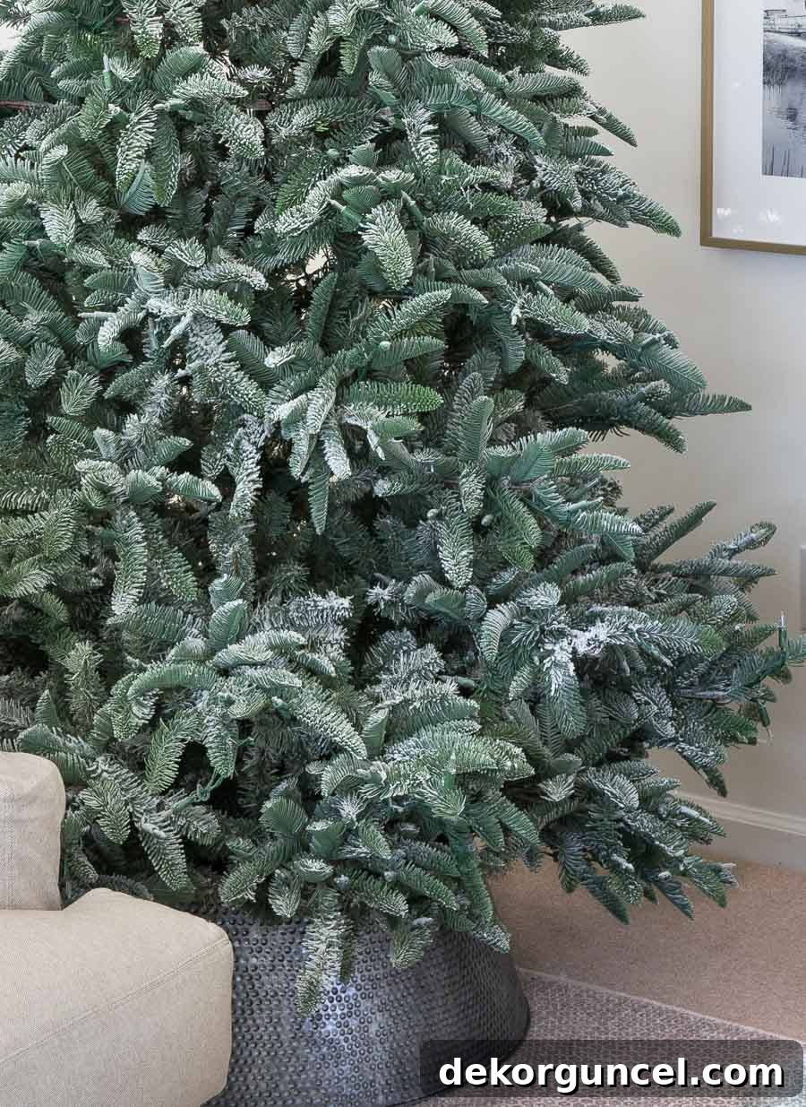 How to Perfectly Flock a Christmas Tree 10 A close-up view of my Christmas tree after successfully applying flocking powder, highlighting the elegant and realistic snow-kissed finish.