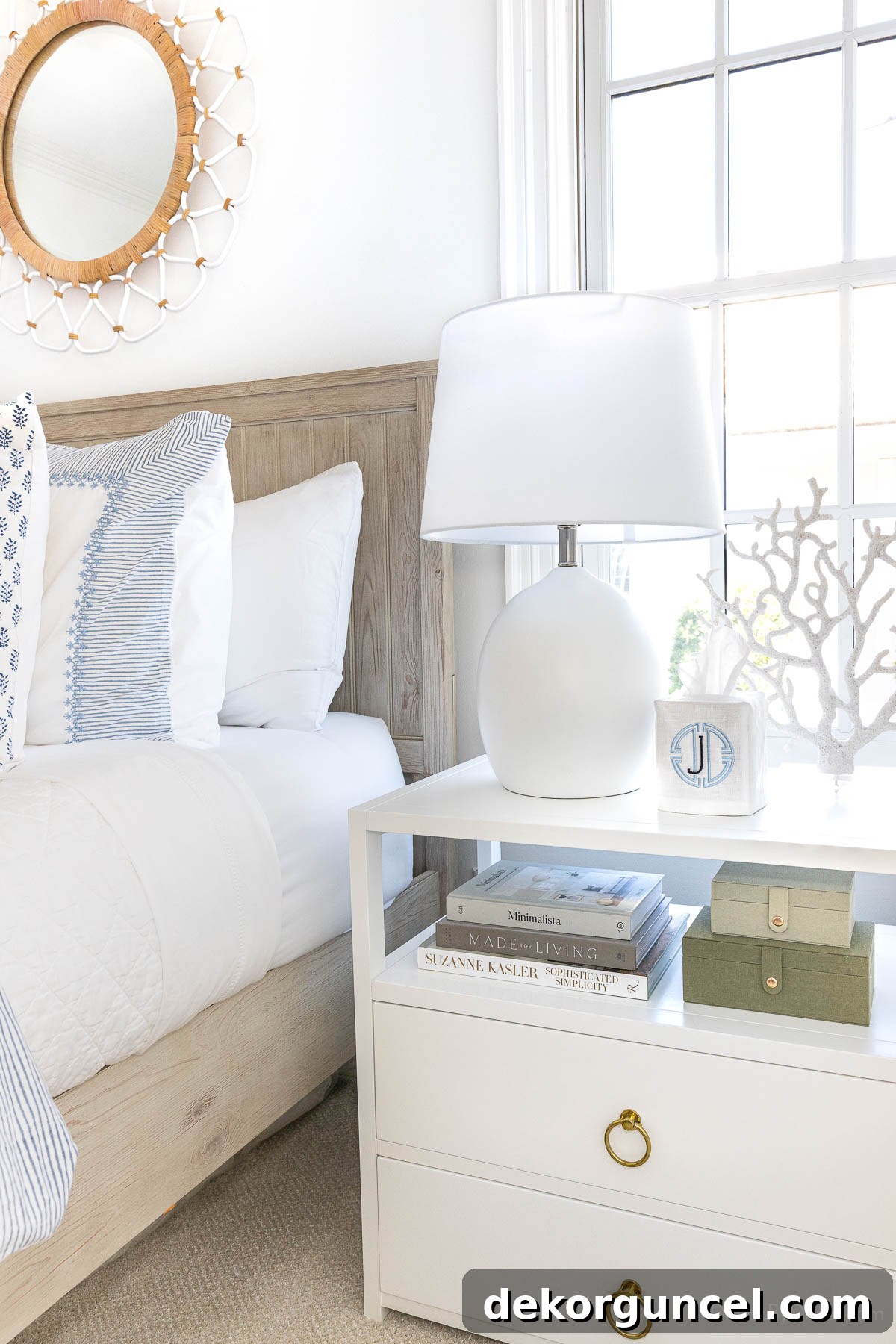 White concrete table lamp on a spacious white nightstand in a bedroom