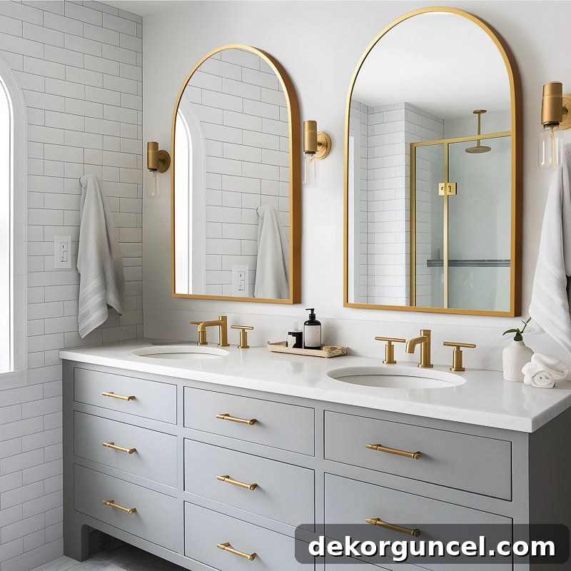 Elegant gold arched mirrors above bathroom sinks