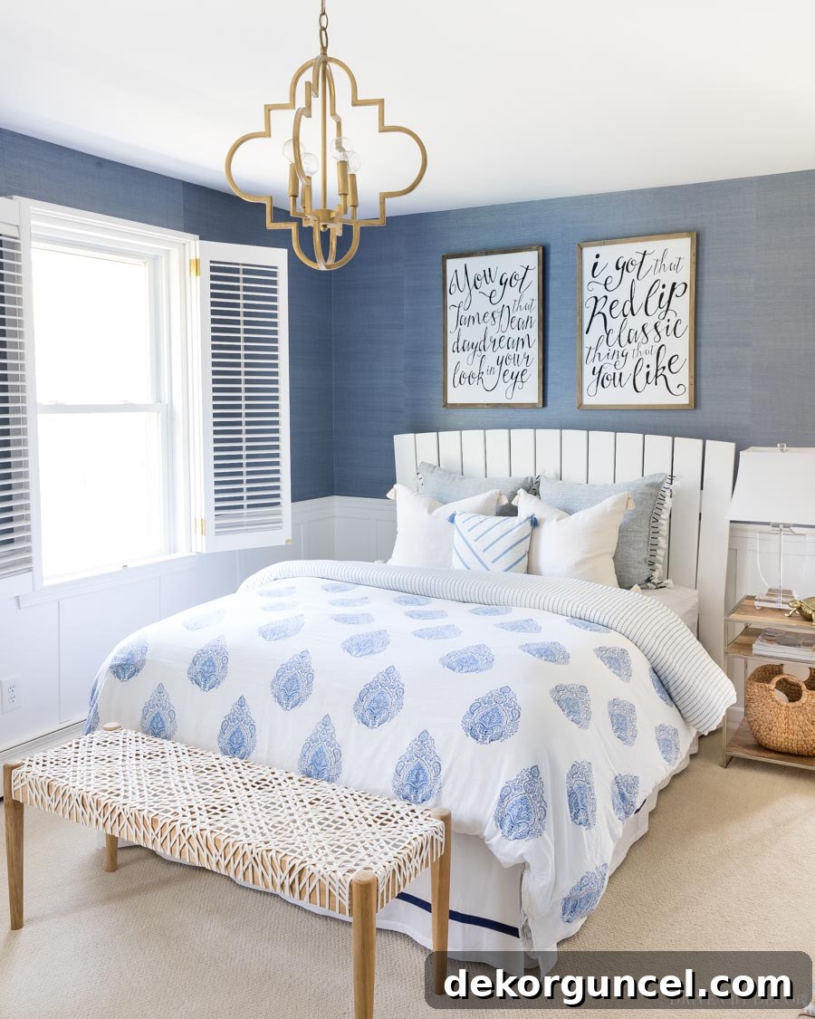 Elegant white leather laced bench at the foot of a queen bed