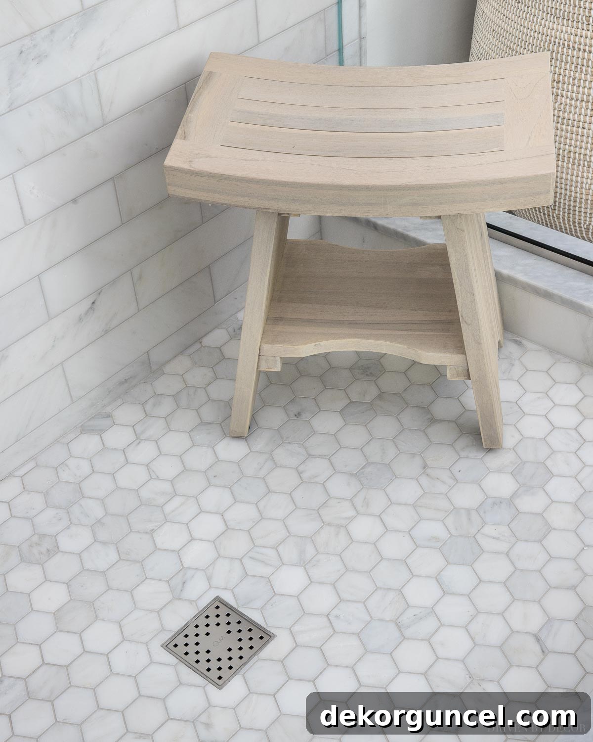 10 Master Bathroom Remodel Ideas You'll Wish Were Yours 4 A stylish freestanding teak shower bench offers a flexible and cost-effective alternative to a built-in option in a master bathroom remodel.