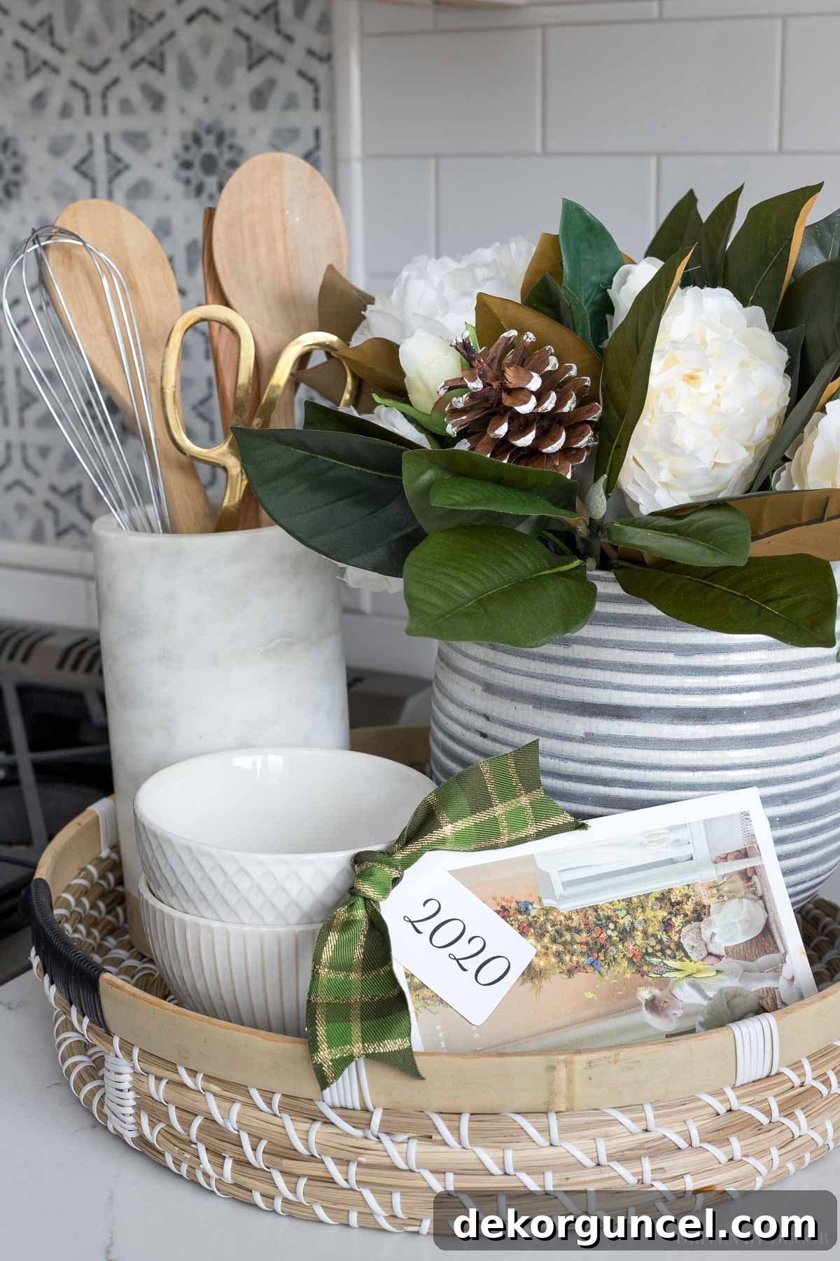 An ingenious idea for displaying Christmas cards: punching a hole in the corner and tying them with ribbon and a dated tag, creating a cherished annual memory book.