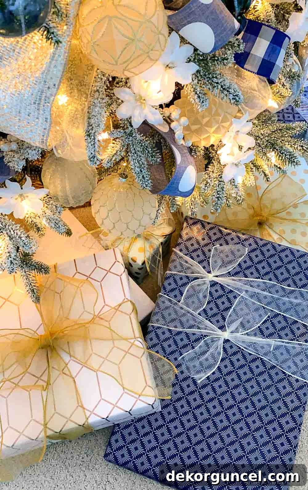 Beautifully wrapped packages in coordinated blue and white, nestled under the festive Christmas tree, ready for holiday gifting.