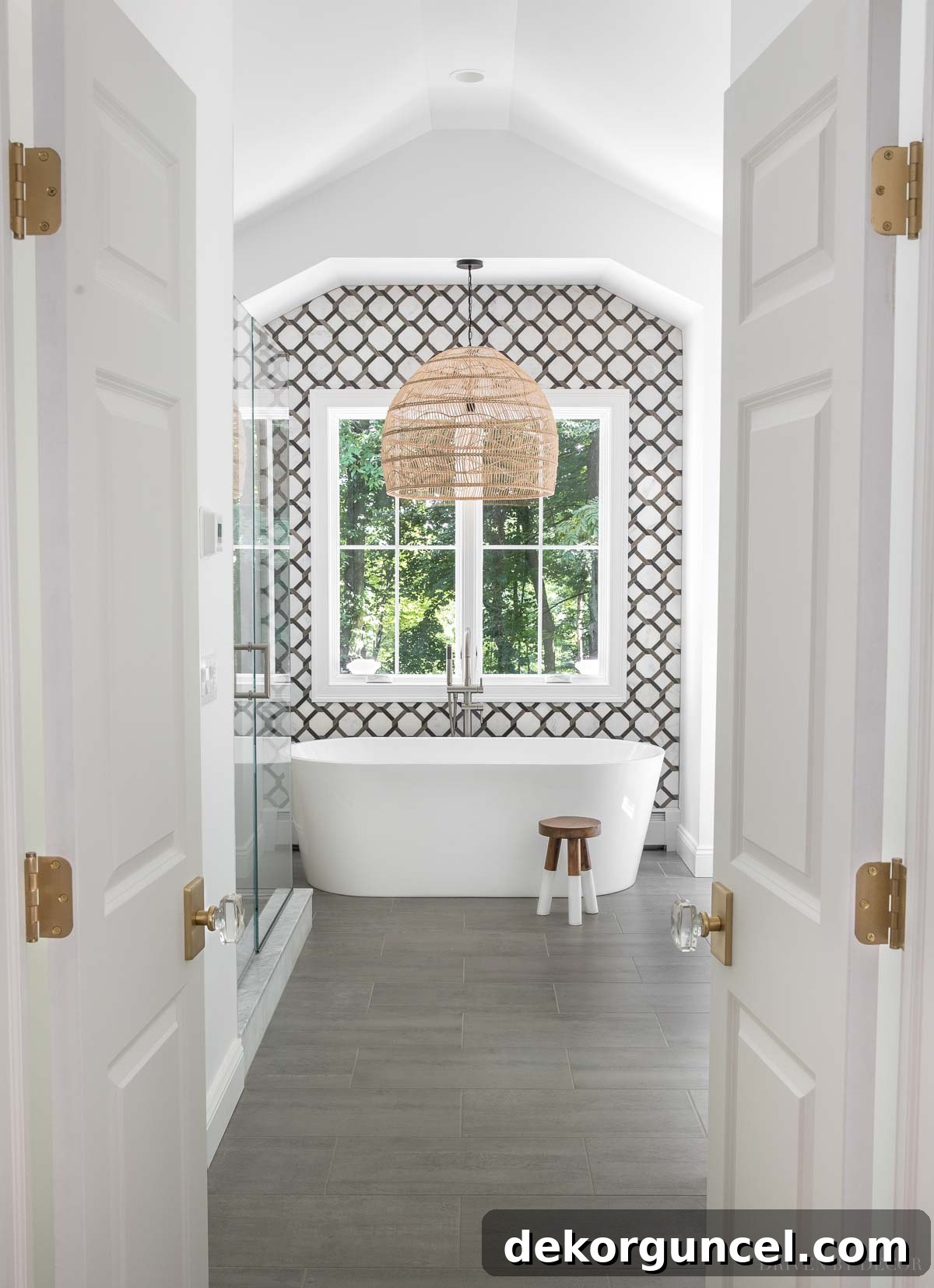 Durable ceramic floor tile in a master bathroom, chosen for practicality and coordinating with marble elements.