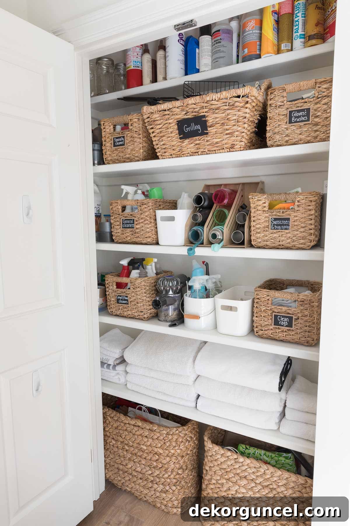 Organized cleaning closet with white bins for dirty microfiber cloths, ensuring a sustainable cleaning routine for marble.