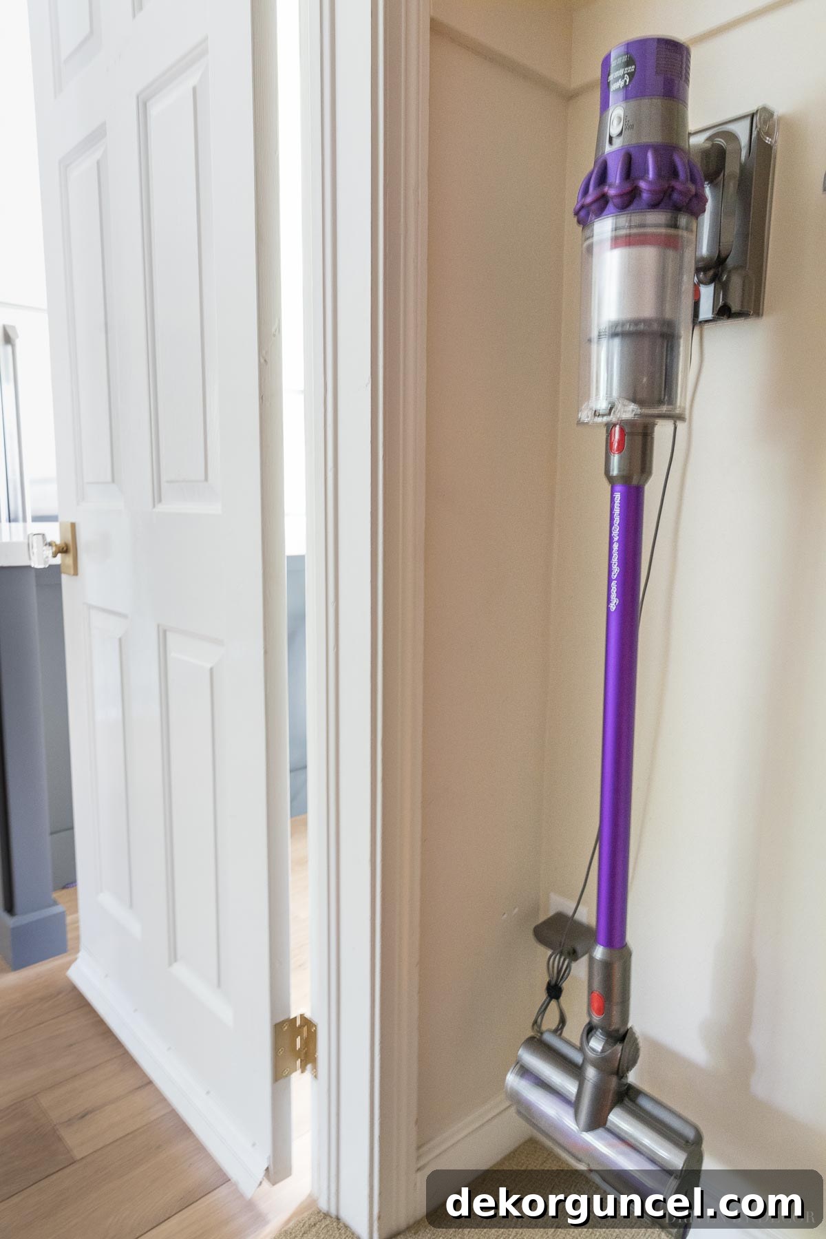 Shark vs. Dyson Cordless Showdown 6 Convenient Dyson cordless vacuum docking station, allowing for easy storage and integrated charging against a wall.