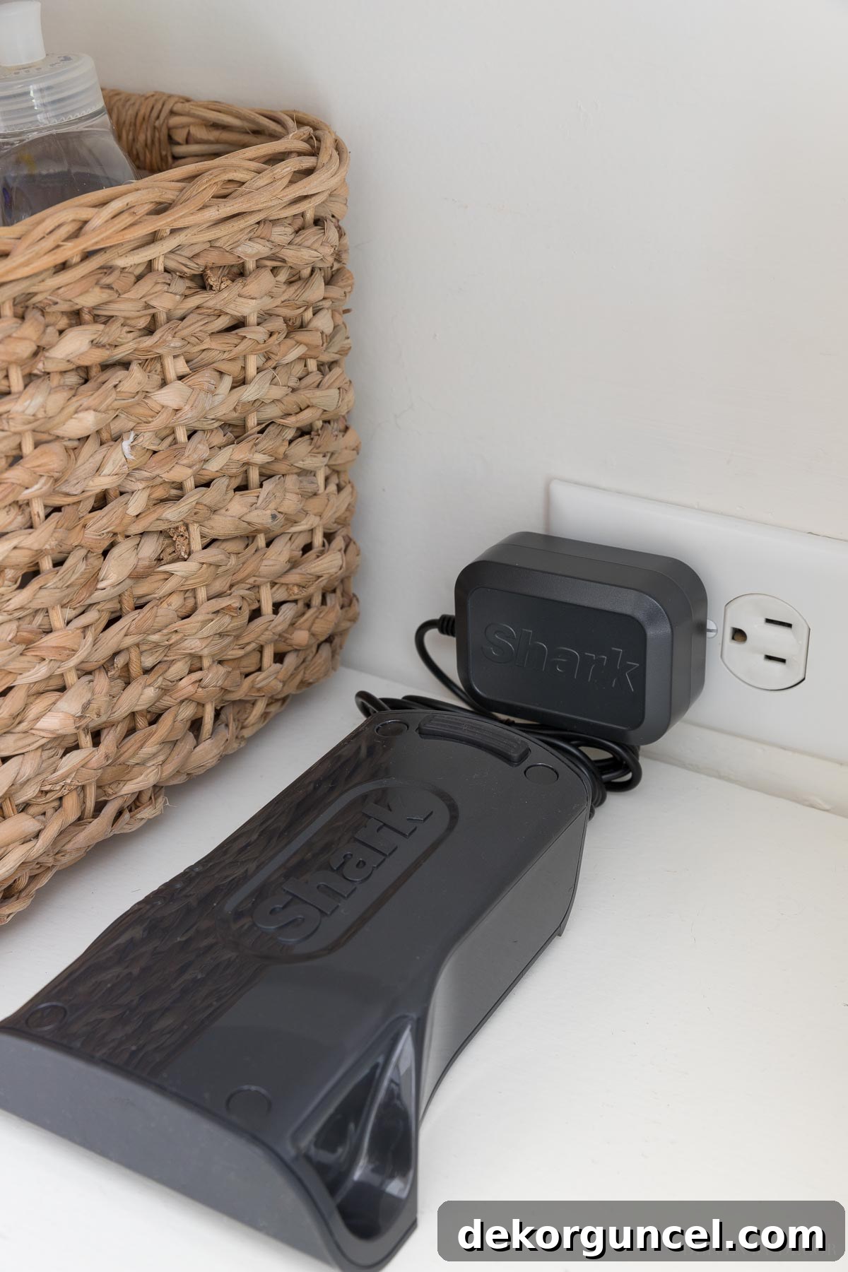 Shark vs. Dyson Cordless Showdown 7 Shark cordless vacuum battery charging in a compact storage closet, highlighting convenience of removable batteries.