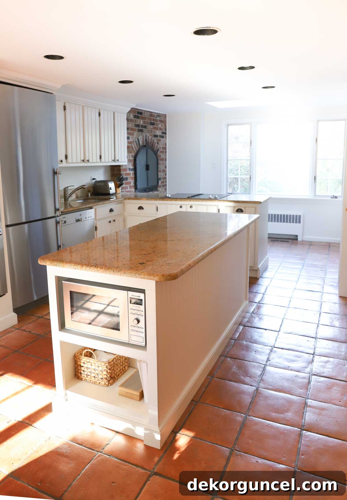 Kitchen before renovation, showing the original brick fireplace