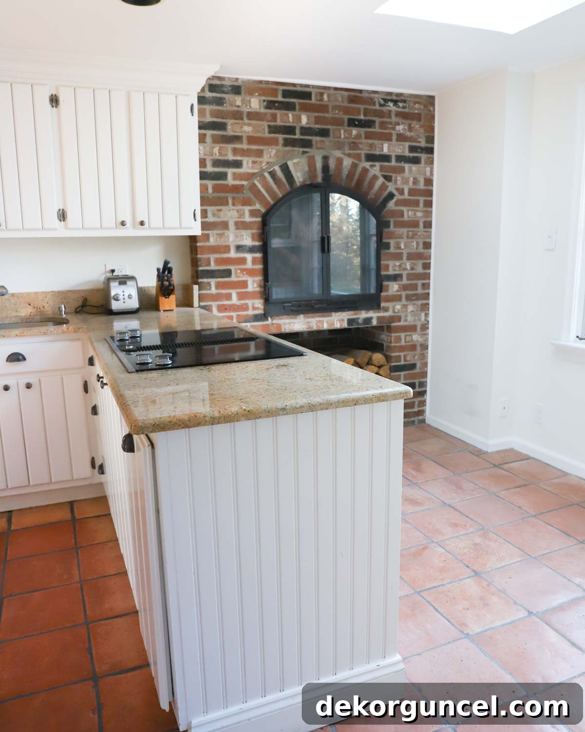 Kitchen before remodel, showing the fireplace as a design constraint