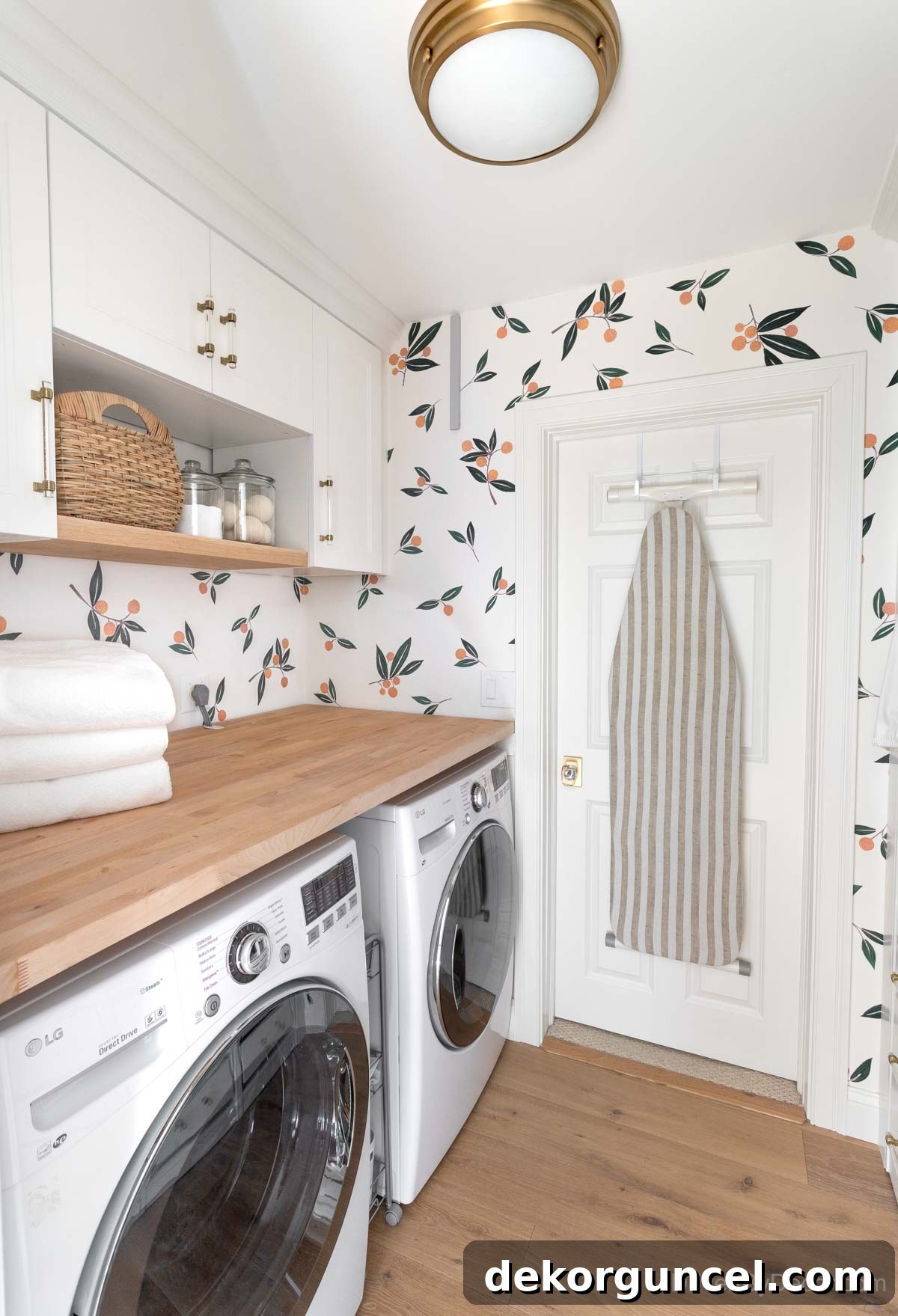 Laundry room after remodeling, featuring a butcher block countertop over the washer and dryer