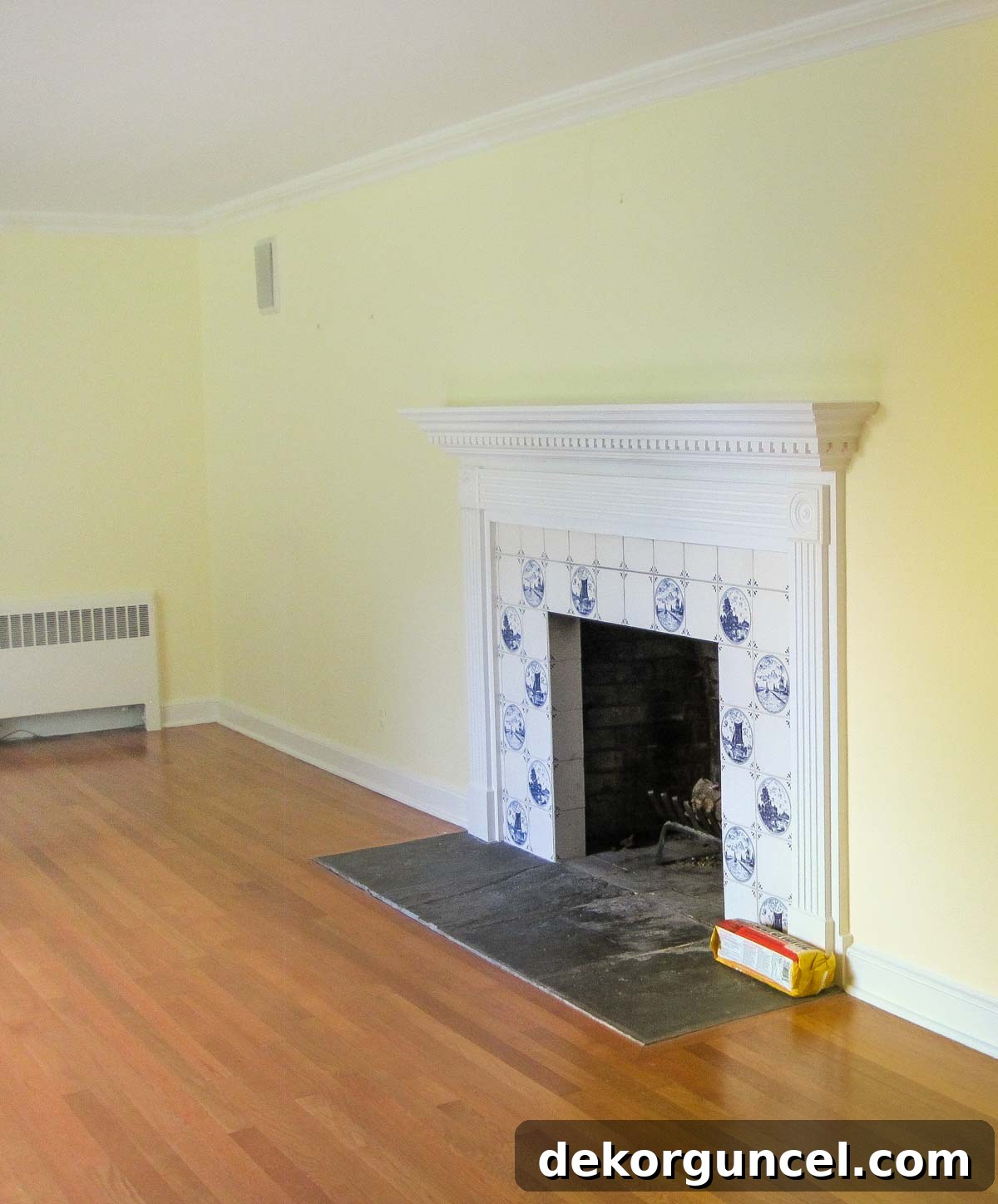 Living room before remodeling, showing the original fireplace with dated tile