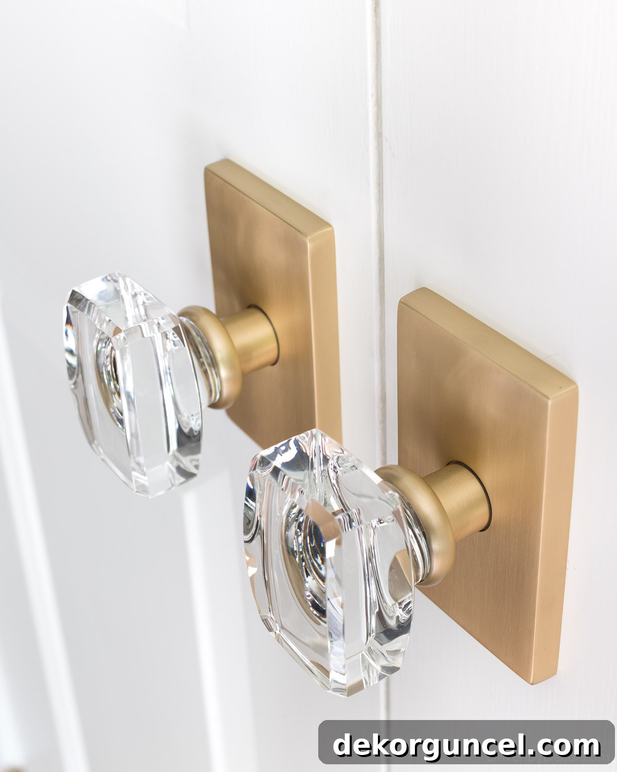 Interior door after renovation, showcasing updated crystal and satin brass knobs with a fresh coat of paint