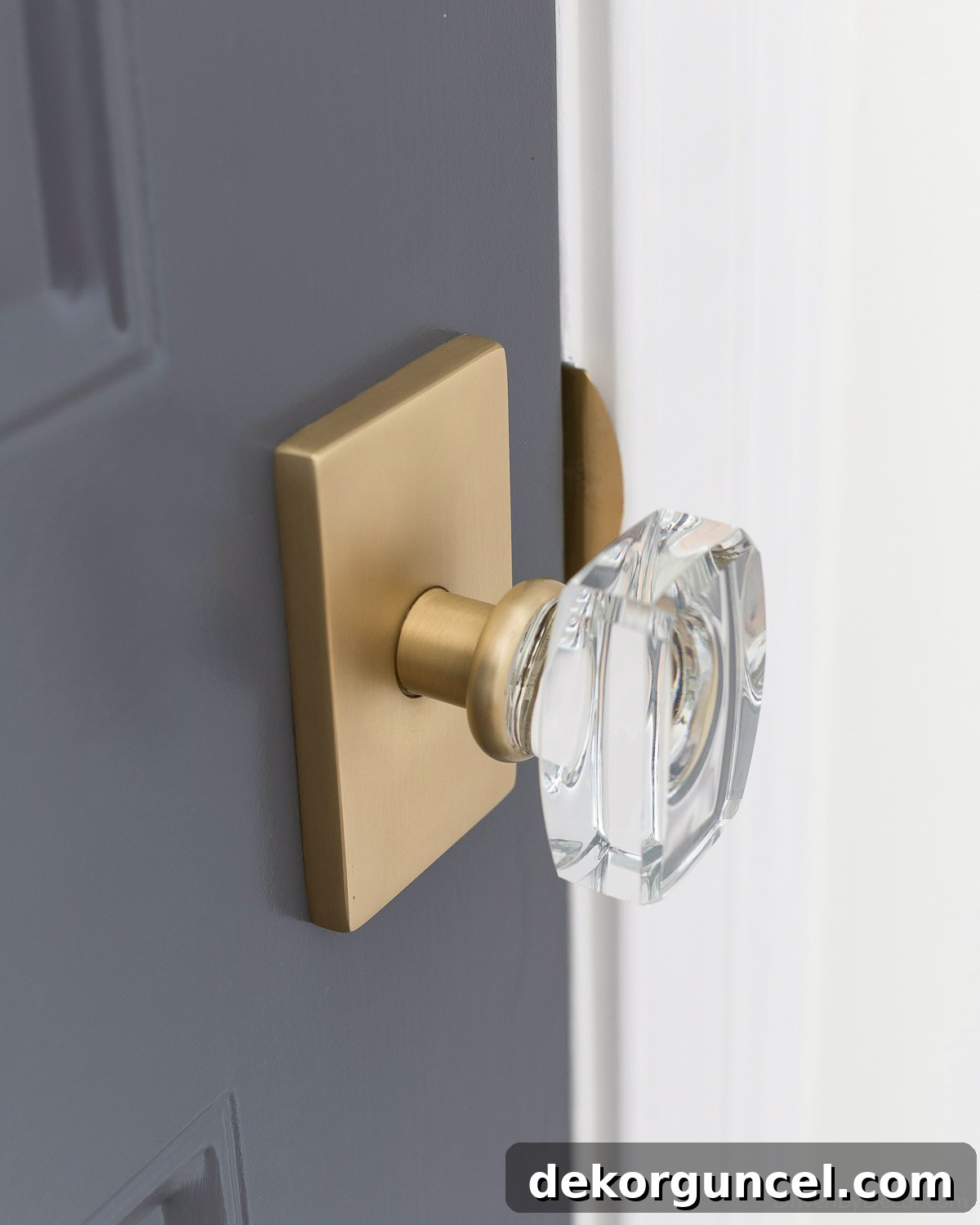 Interior entry door painted in Benjamin Moore Charcoal Slate, complemented by new brass and crystal hardware