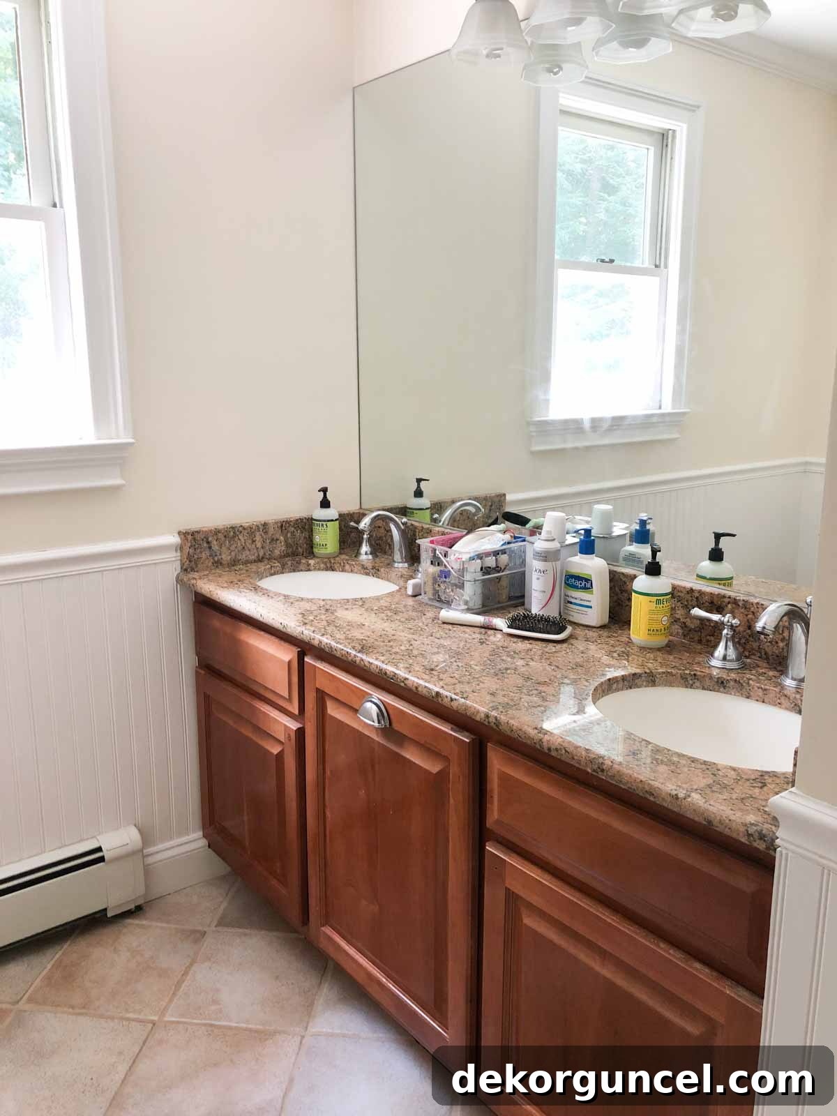 Kids' bathroom before remodeling, featuring dark, worn cabinets