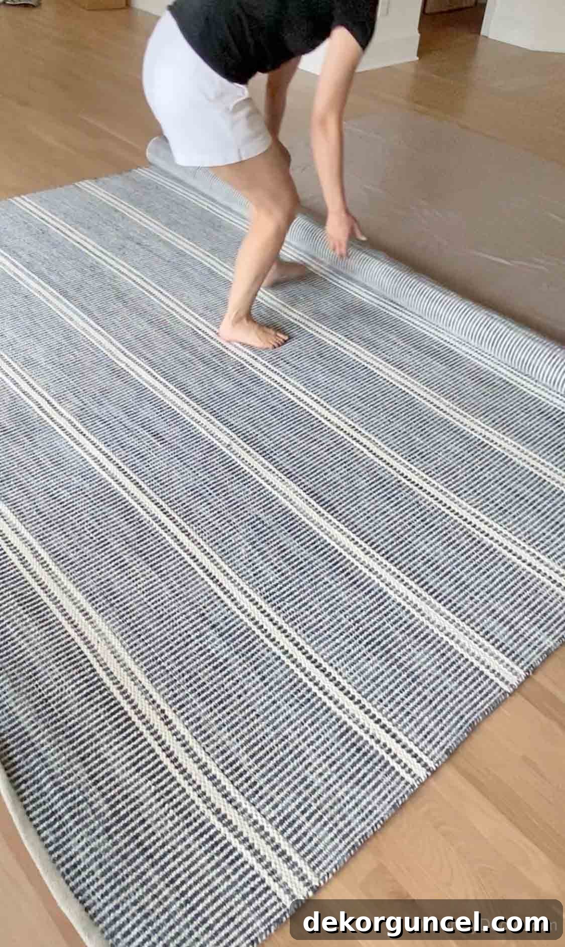 The exciting moment of unrolling our new blue and white family room rug, ready to anchor the space.