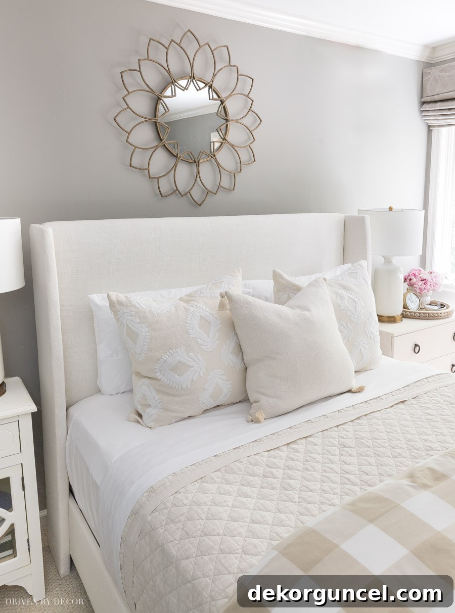 Stunning gold petal mirror serving as elegant above bed decor, enhancing the guest room's style.