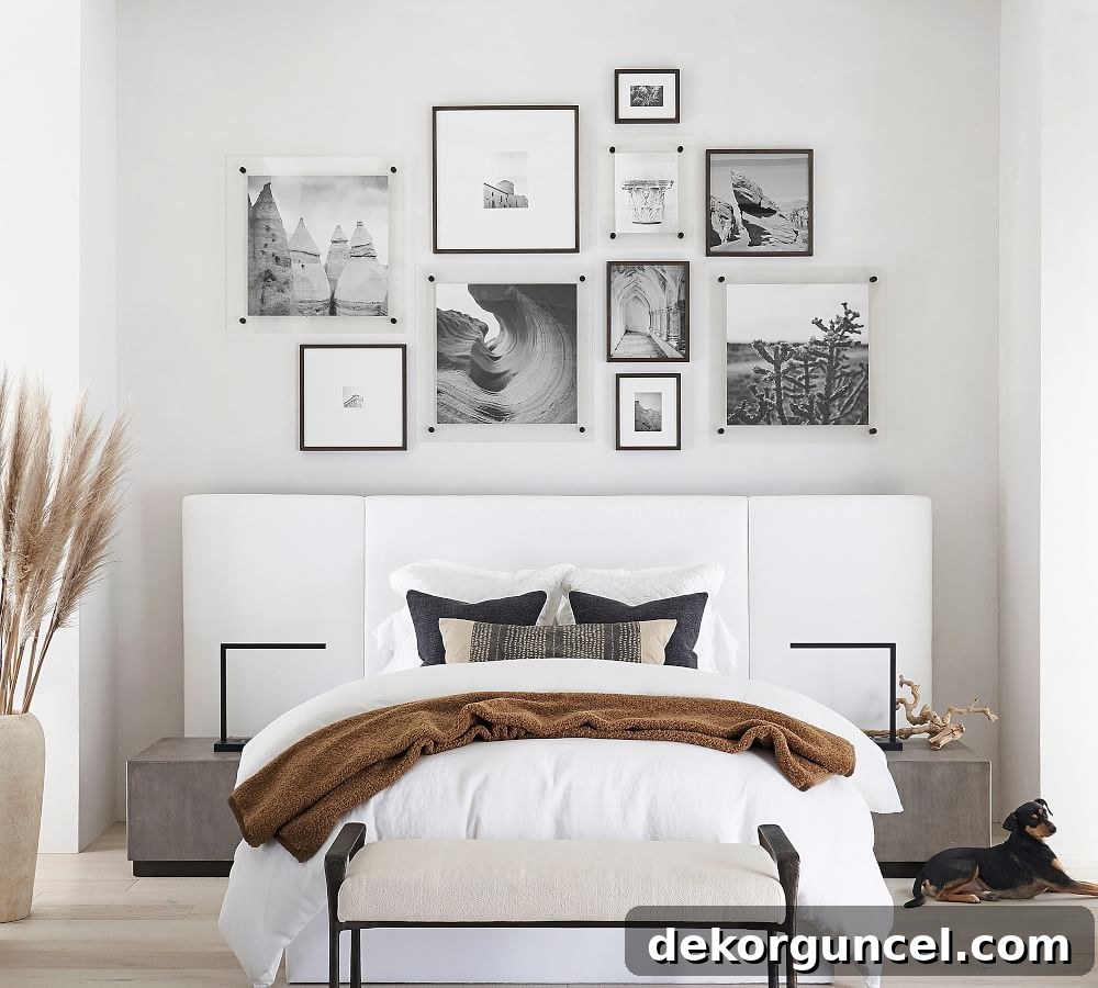 Beautifully arranged gallery wall with mixed black wood and acrylic frames as above bed decor.