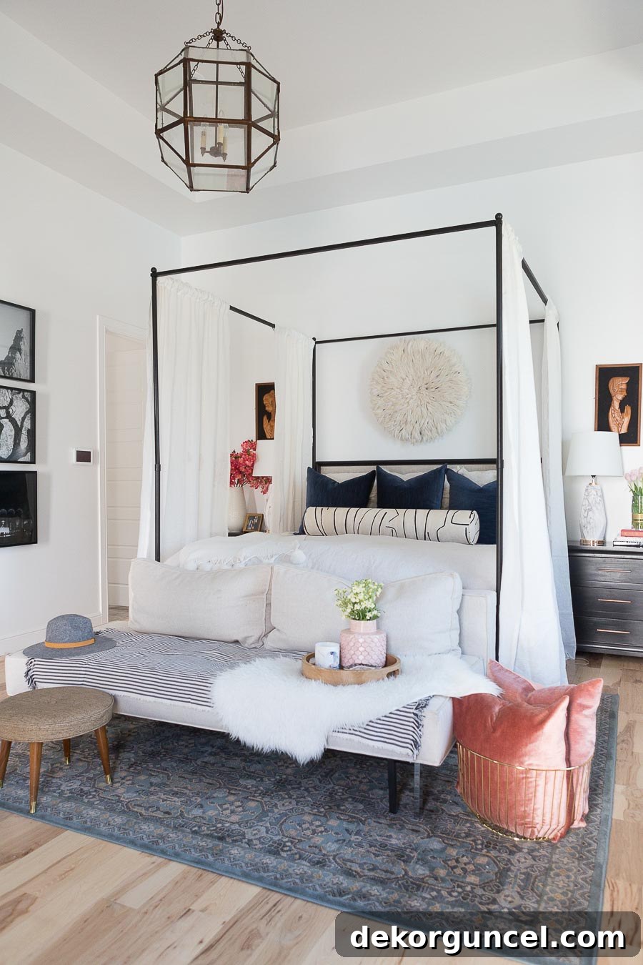 Exquisite feathery juju hat prominently displayed as above bed decor, adding organic texture and elegance.