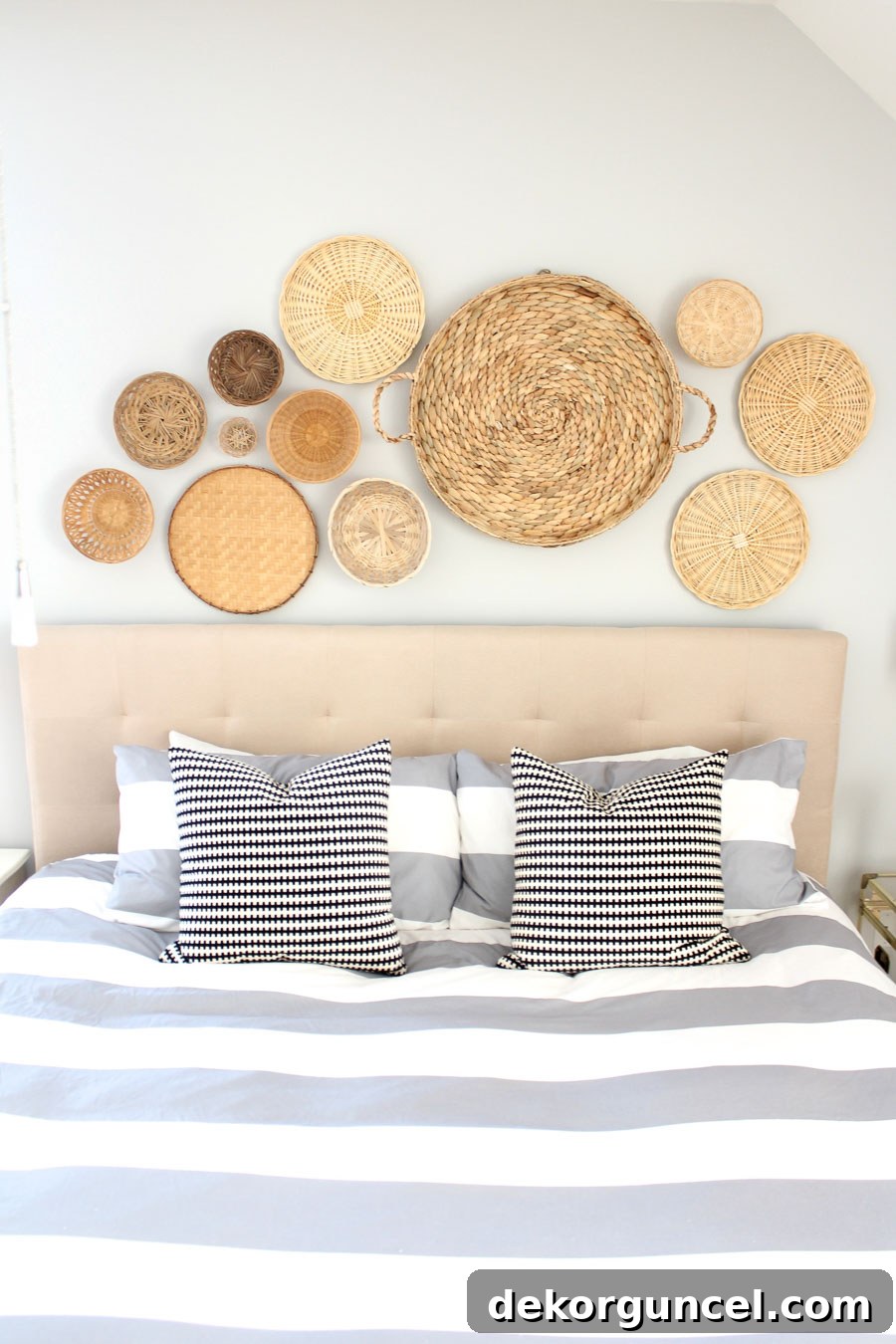 Beautiful grouping of woven baskets arranged as above bed decor, showcasing texture and artisanal charm.